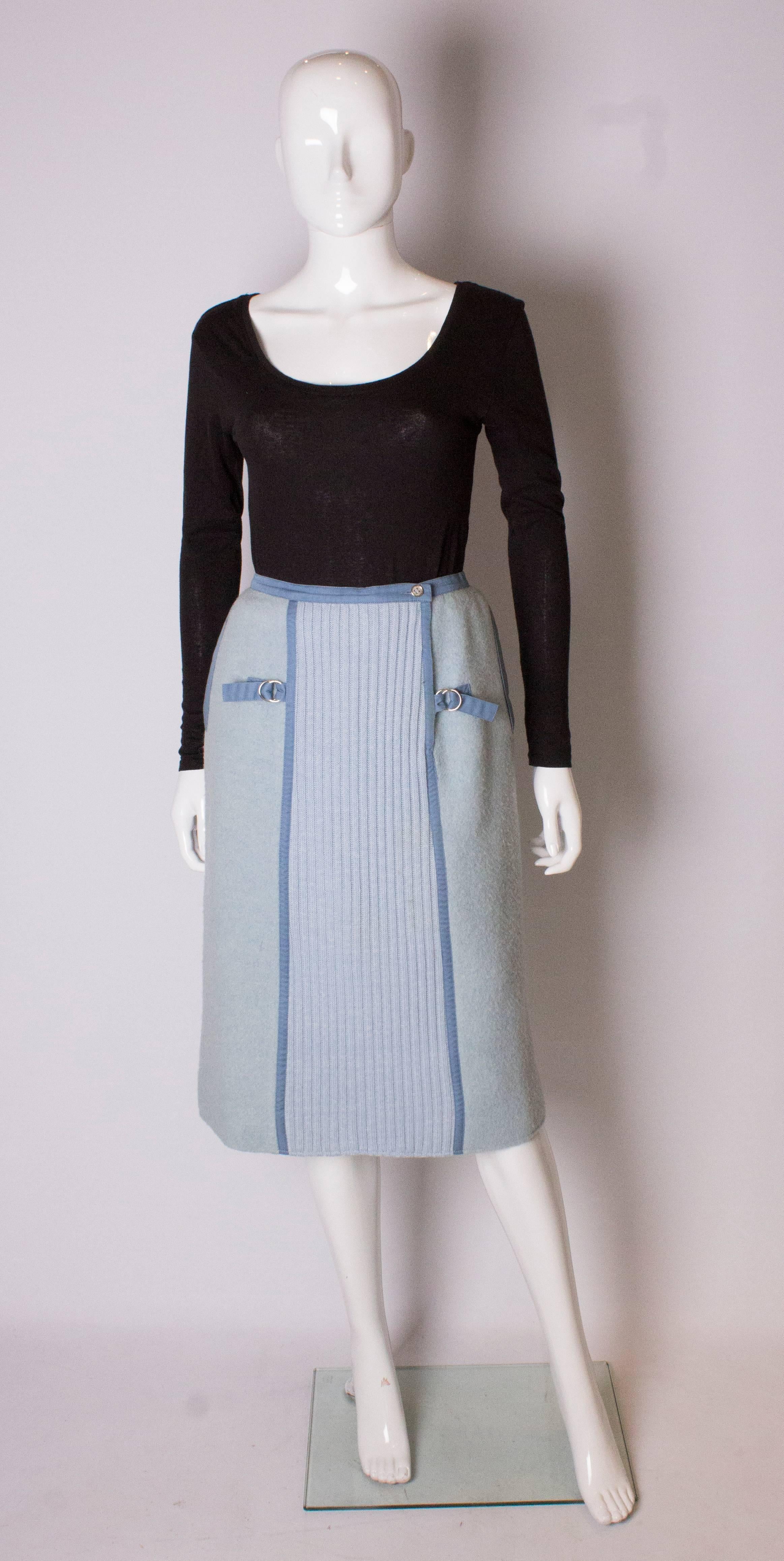 A chic vintage  skirt by Courreges. In a sky blue wool with knit detail, the skirt is fully lined and has two pockets.