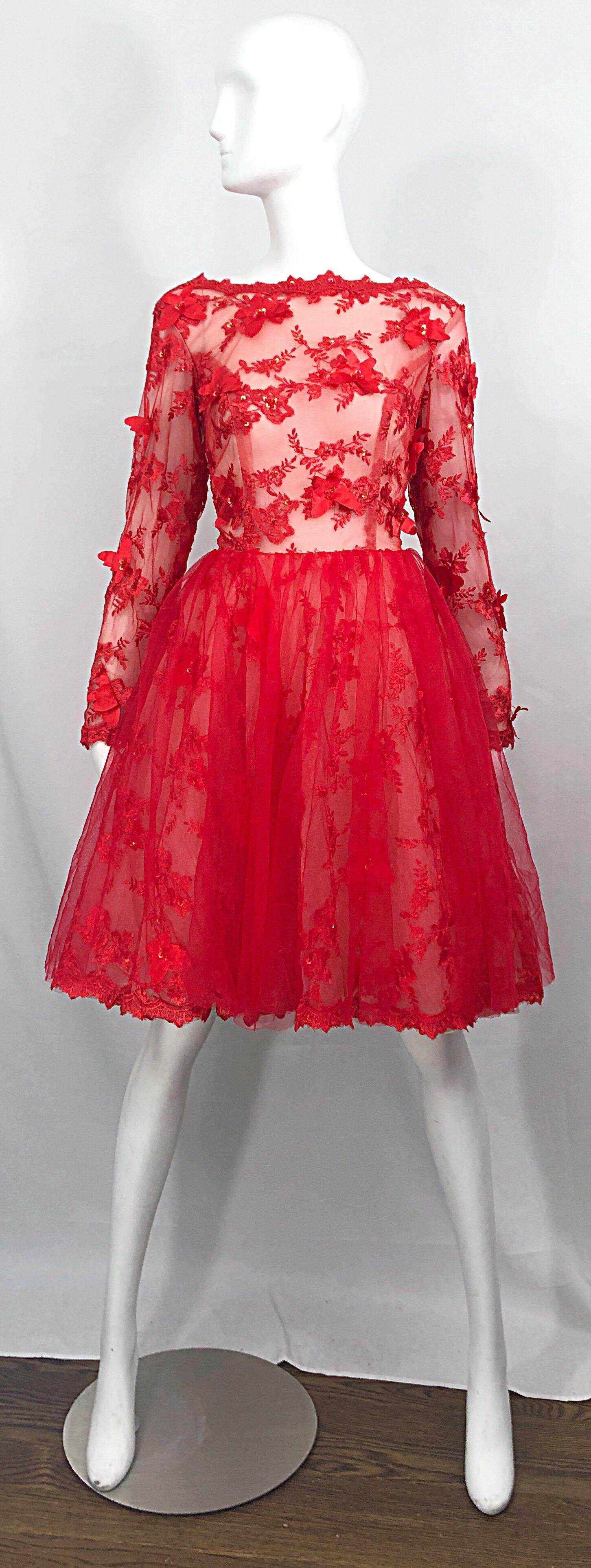 Sensational 90s does 50s couture quality Size 10 / 12 fit n' flare long sleeve cocktail dress. Features a semi sheer mesh bodice with red silk appliqués with rhinestones throughout. Forgiving full skirt features a mesh overlay with red lace