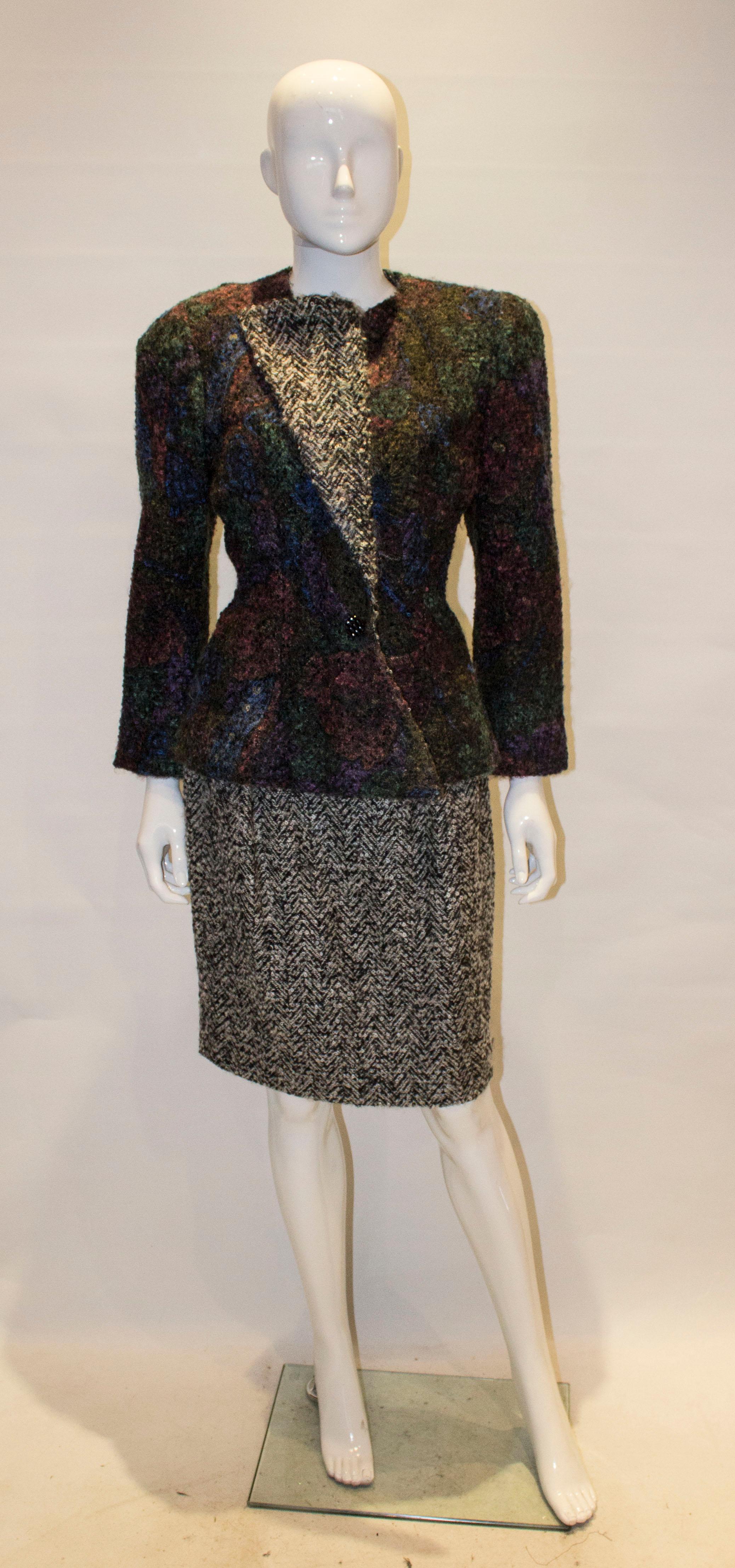 A chic coutuer vintage skirt suit. The jacket is in a multicolour boucle with zip up front and weights in the hem , so hangs beautifully . The body of the jacket is unlined but the sleeves are lined.  The skirt is in a black and white boucle with a