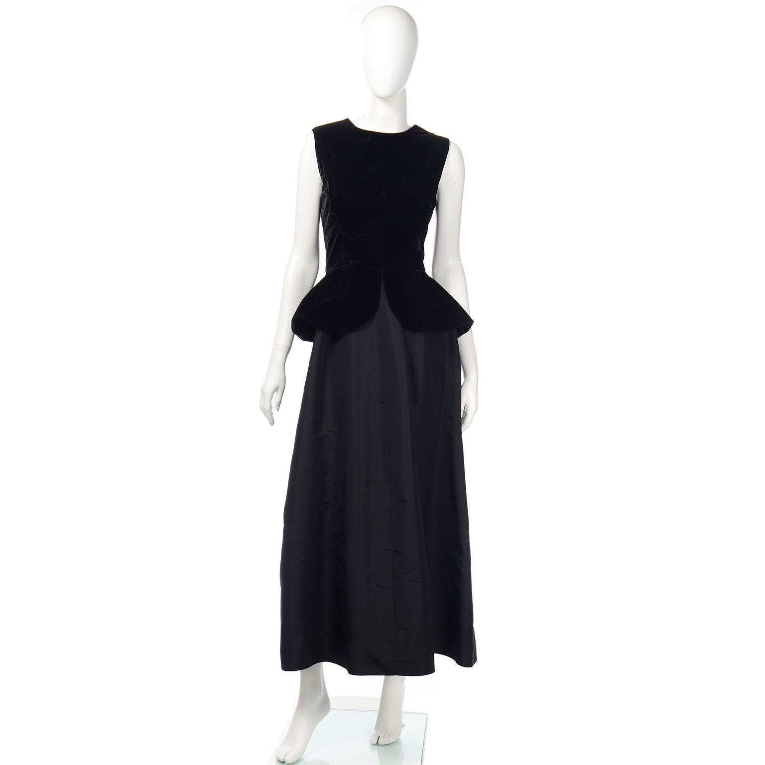 This is an elegant all black vintage evening dress from Givenchy with a velvet bodice and peplum and a satin long skirt. Perfect for any black tie event or special evening. This gorgeous sleeveless evening gown has a round neckline and closes with a