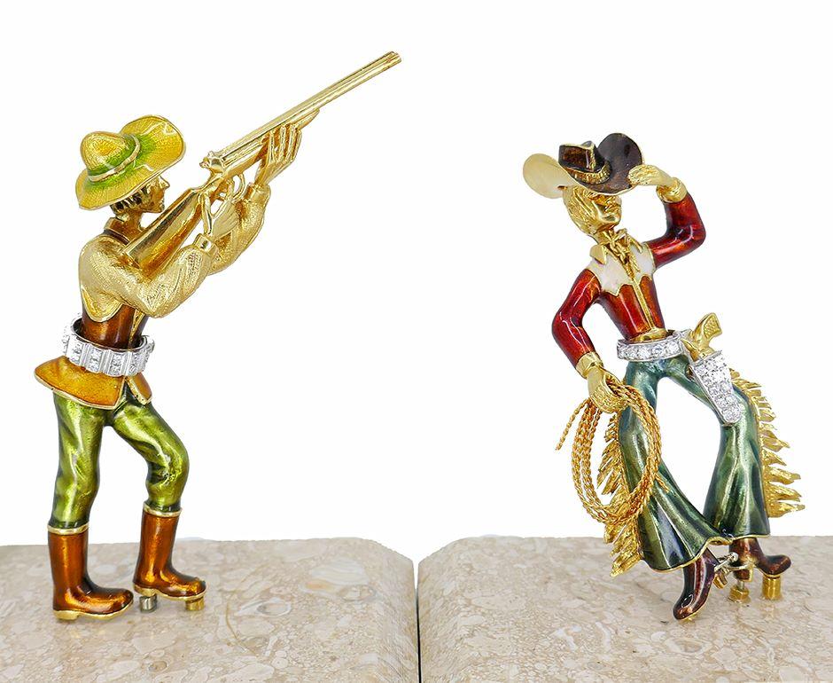 Two amazing vintage cowboy figurines made of 18k gold, diamond, and enamel by an Italian jeweler Pier Damiano Grassi in the 1960s. 
One little gold statue pictures a cowboy touching his hat and holding a ranch rope. He is dressed in a red and white