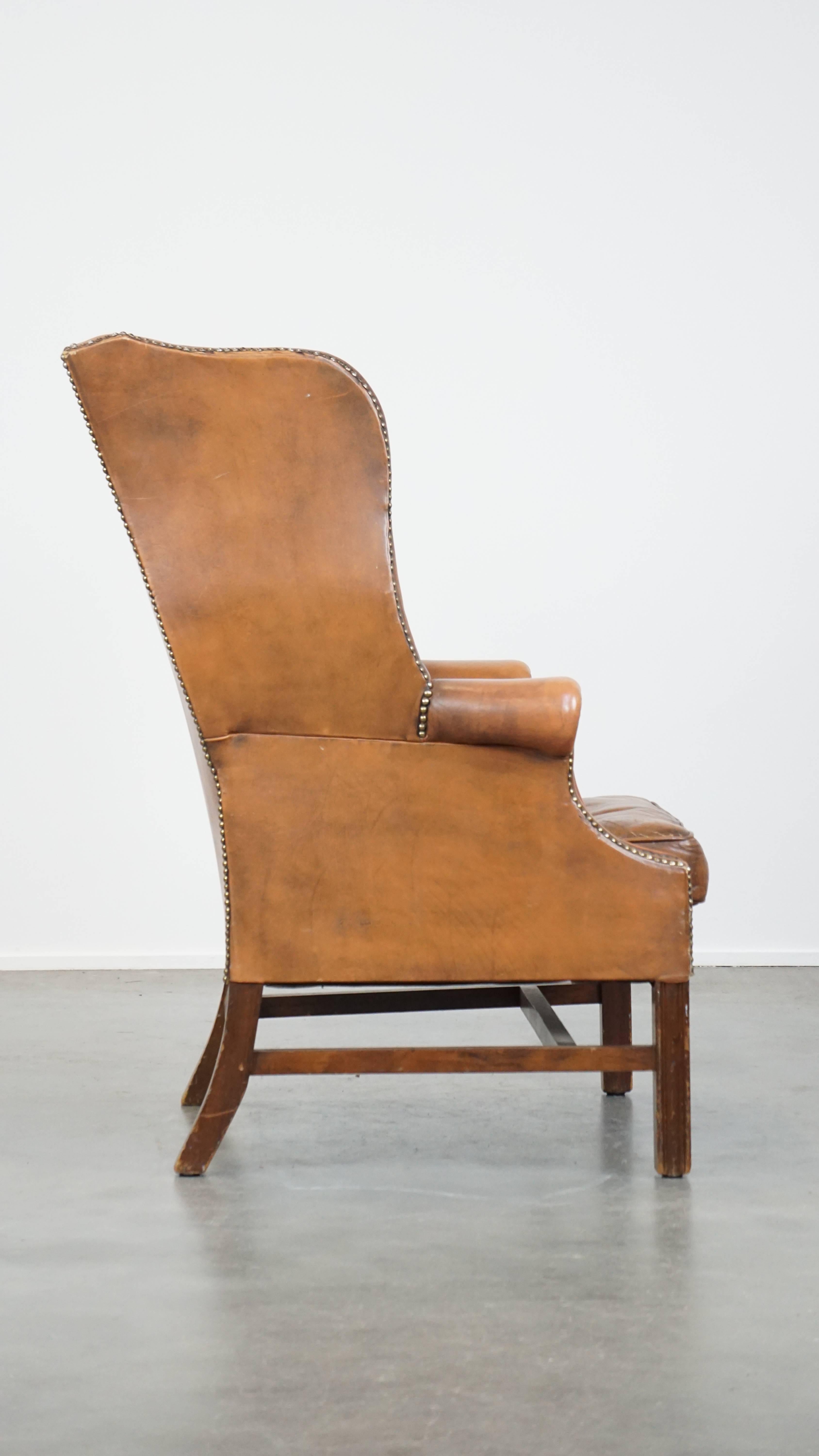 Hand-Crafted Vintage cowhide leather English Chesterfield wingback chair, light cognac color For Sale