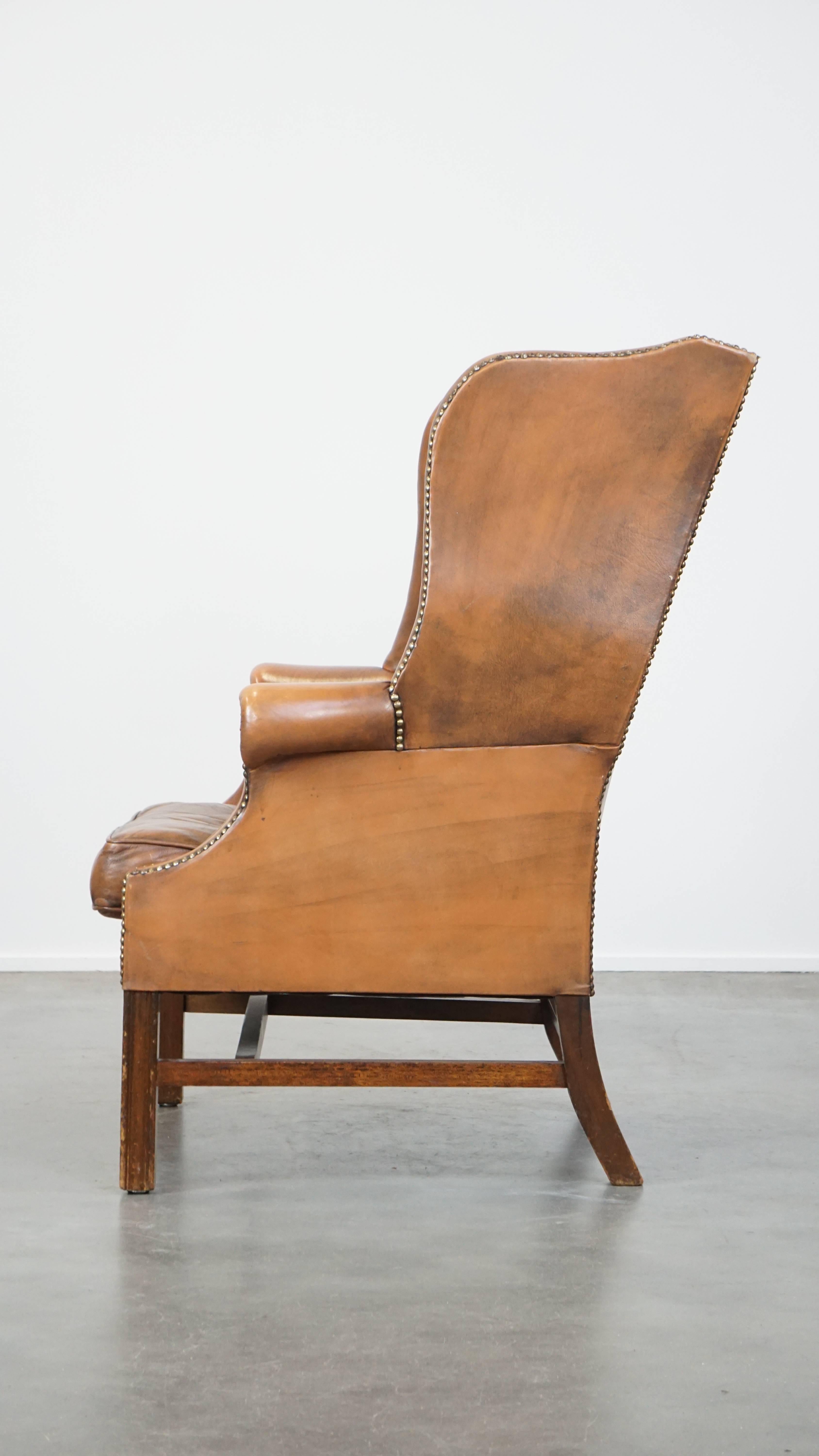 20th Century Vintage cowhide leather English Chesterfield wingback chair, light cognac color For Sale