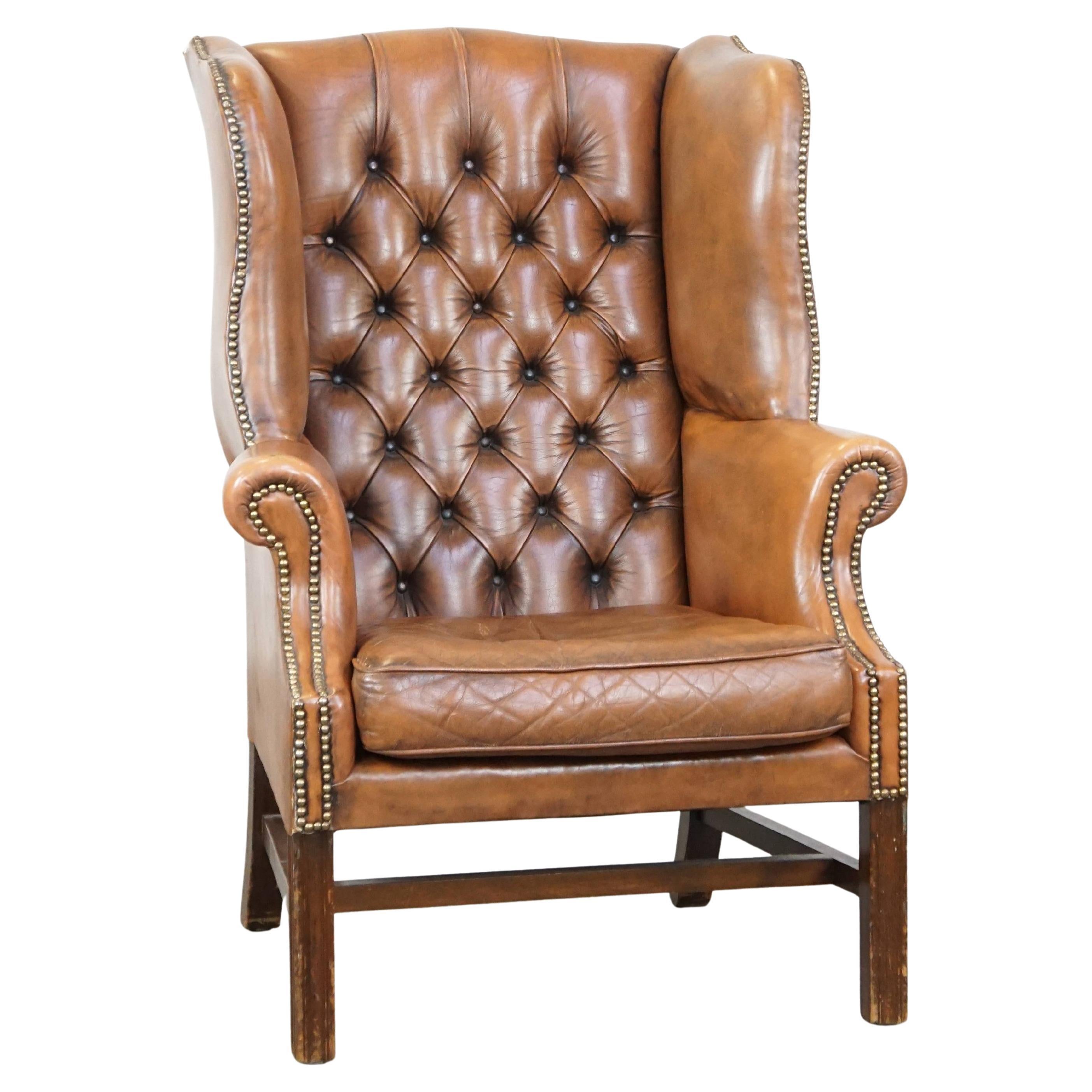 Vintage cowhide leather English Chesterfield wingback chair, light cognac color For Sale