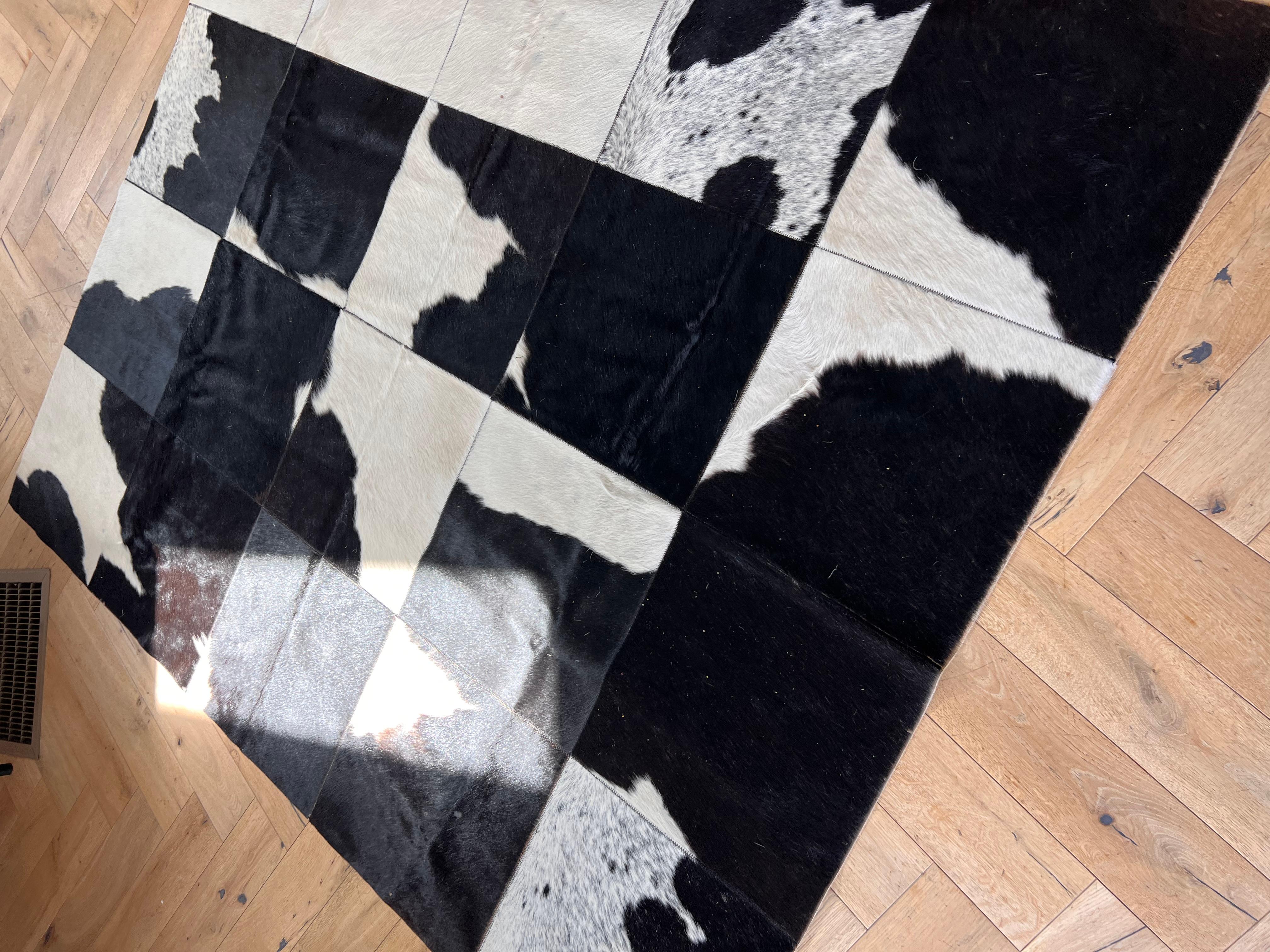A vintage patchwork rug made of cowhide, circa early 1970s. A design that was later appropriated by Ralph Lauren for his home interiors collection. Some minor signs of age as shown in photos but no outward flaws. Pick up in central west Los Angeles
