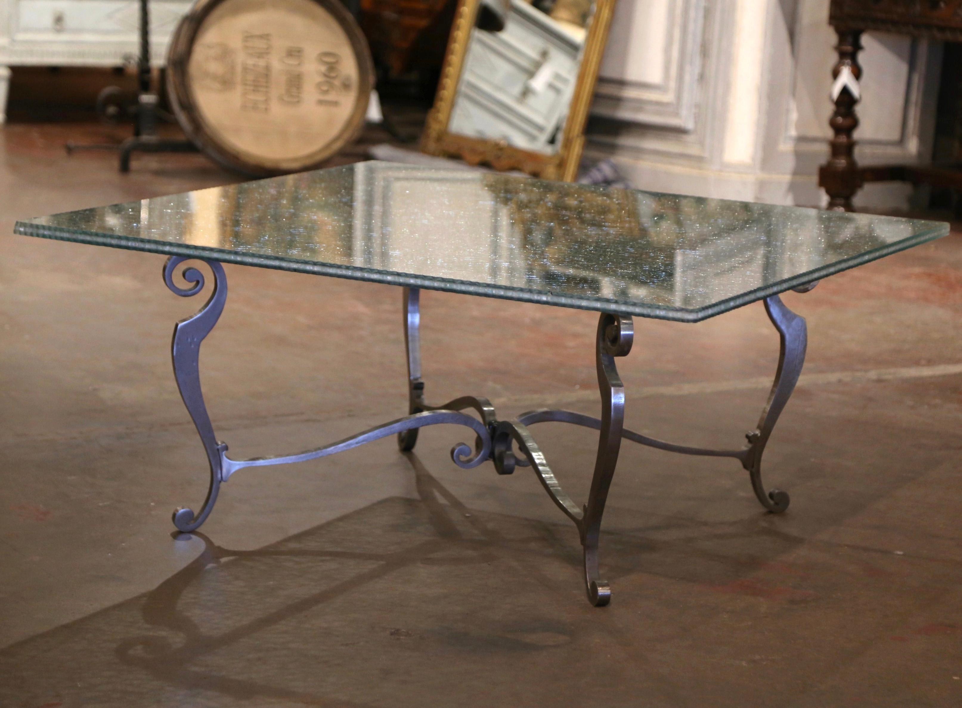 This unusual cocktail table would make an interesting addition to any living room, sitting area, office, or den. Square in shape, the elegant table stands on four cabriole legs, embellished with scroll motifs, and connected with a curved center