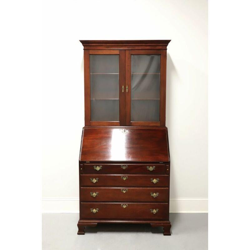 A stunning secretary desk with bookcase by top-quality furniture maker Craftique, in the style of early American John Hancock desks. Solid mahogany with their Old Wood finish, brass hardware, crown moulding to top, brass keyhole escutcheons, and