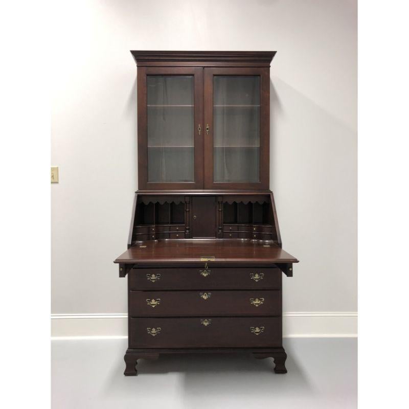 A stunning secretary desk with bookcase by top-quality furniture maker Craftique, in the style of early American John Hancock desks. Made in Mebane, North Carolina, USA, in 1976. Solid mahogany with brass hardware. Upper bookcase has two fixed