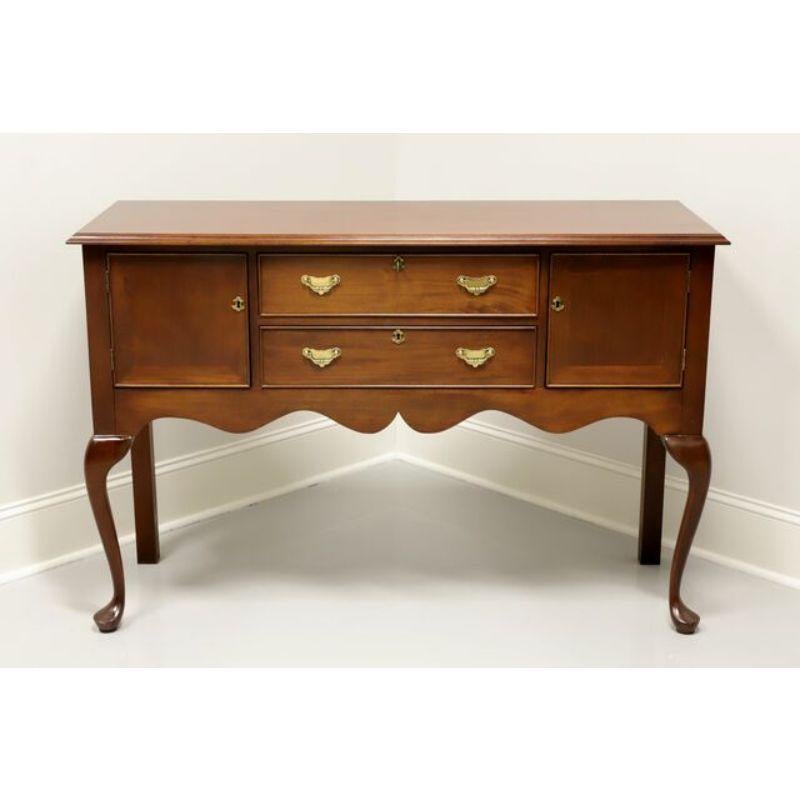 A Georgian style huntboard by Craftique. Mahogany with their Mellowax finish, brass hardware, straight back legs and cabriole front legs with pad feet. Features two center felt lined dovetail drawers flanked by side storage cabinets. Drawers and