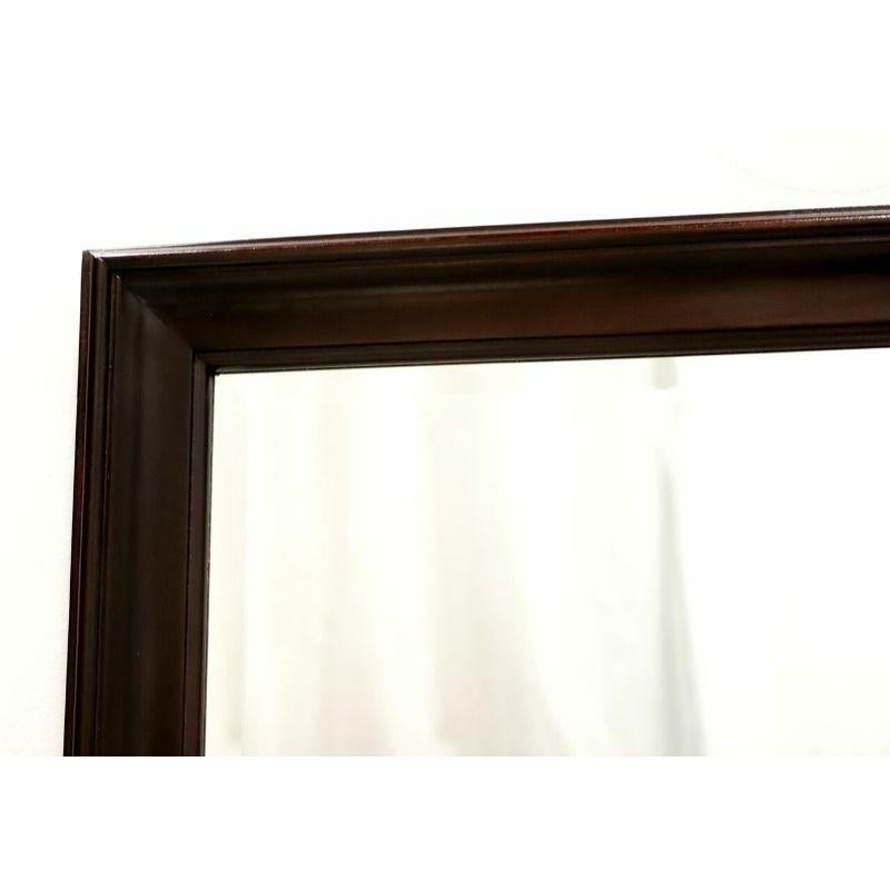 A Traditional style rectangular dresser or wall mirror by top-quality furniture maker Craftique. Beveled mirror glass in a solid mahogany frame with their New Oxford finish. Made in Mebane, North Carolina, USA, in the late 20th Century.

Measures: