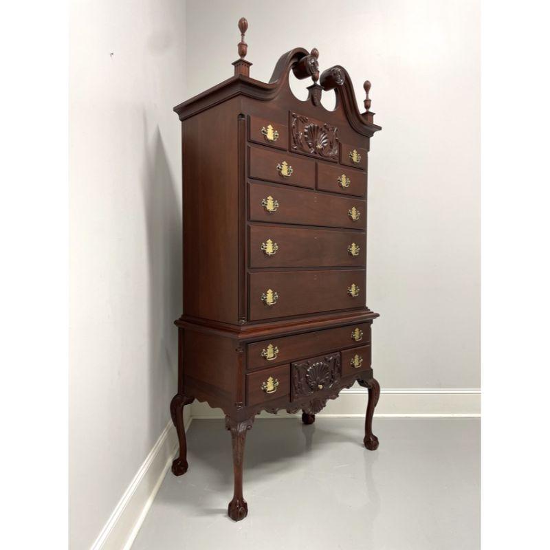 A Chippendale Philadelphia style highboy chest on chest by high-quality furniture maker Craftique. Solid mahogany with their Mellowax finish, brass hardware, pediment top with center & side finials, shell carvings, carved apron, carved knees,