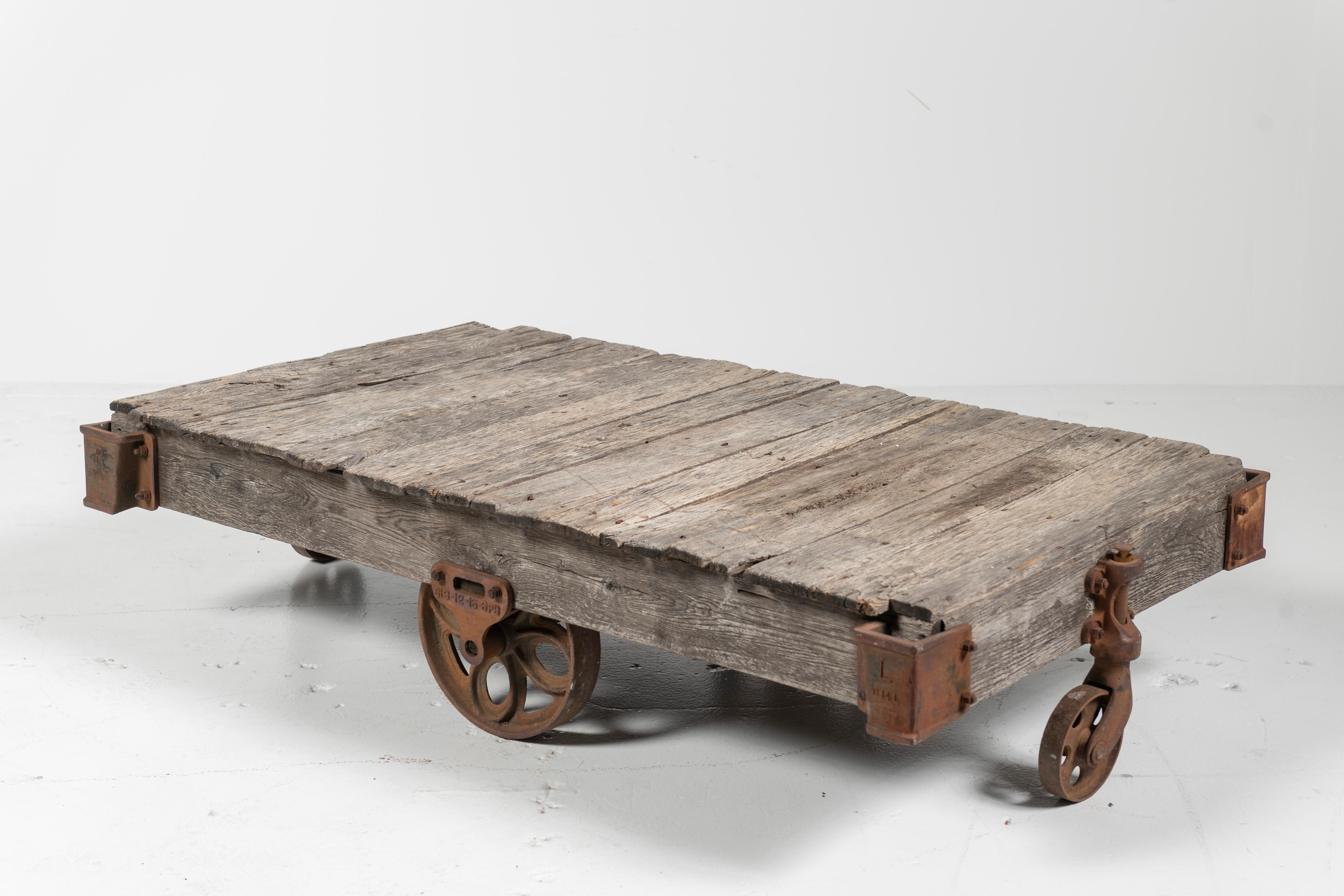 Typically, these coffee tables began as salvage carts to load and unload goods from railroads and other transporters. The carts were repurposed in the late 20th Century as coffee tables with an industrial edge. The cast iron wheels and corners are