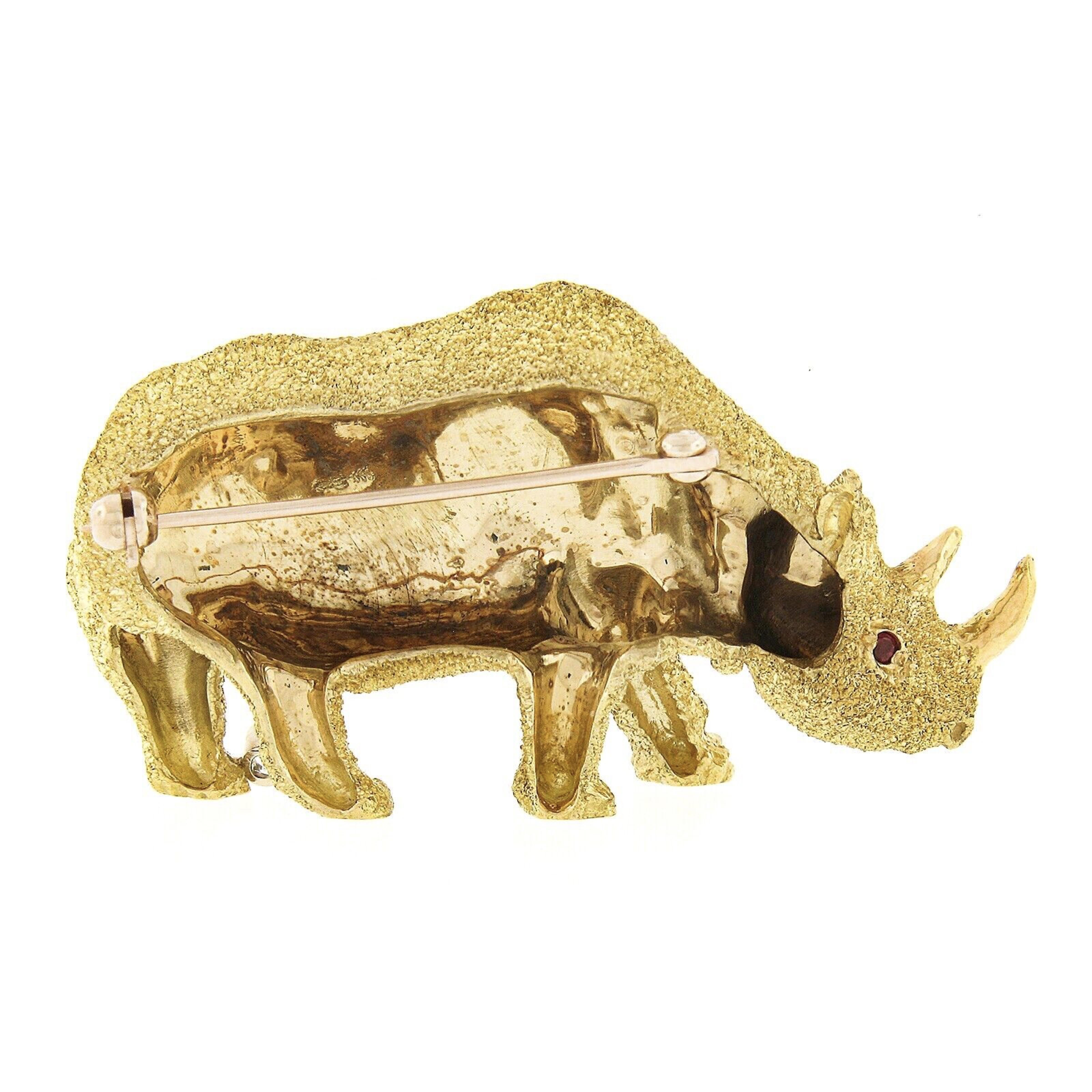This incredible vintage brooch/pin is designed by Craig Drake and very well crafted in solid 18k yellow gold. It features a perfectly structured standing rhinoceros design with unique, and remarkably outstanding workmanship and texture throughout