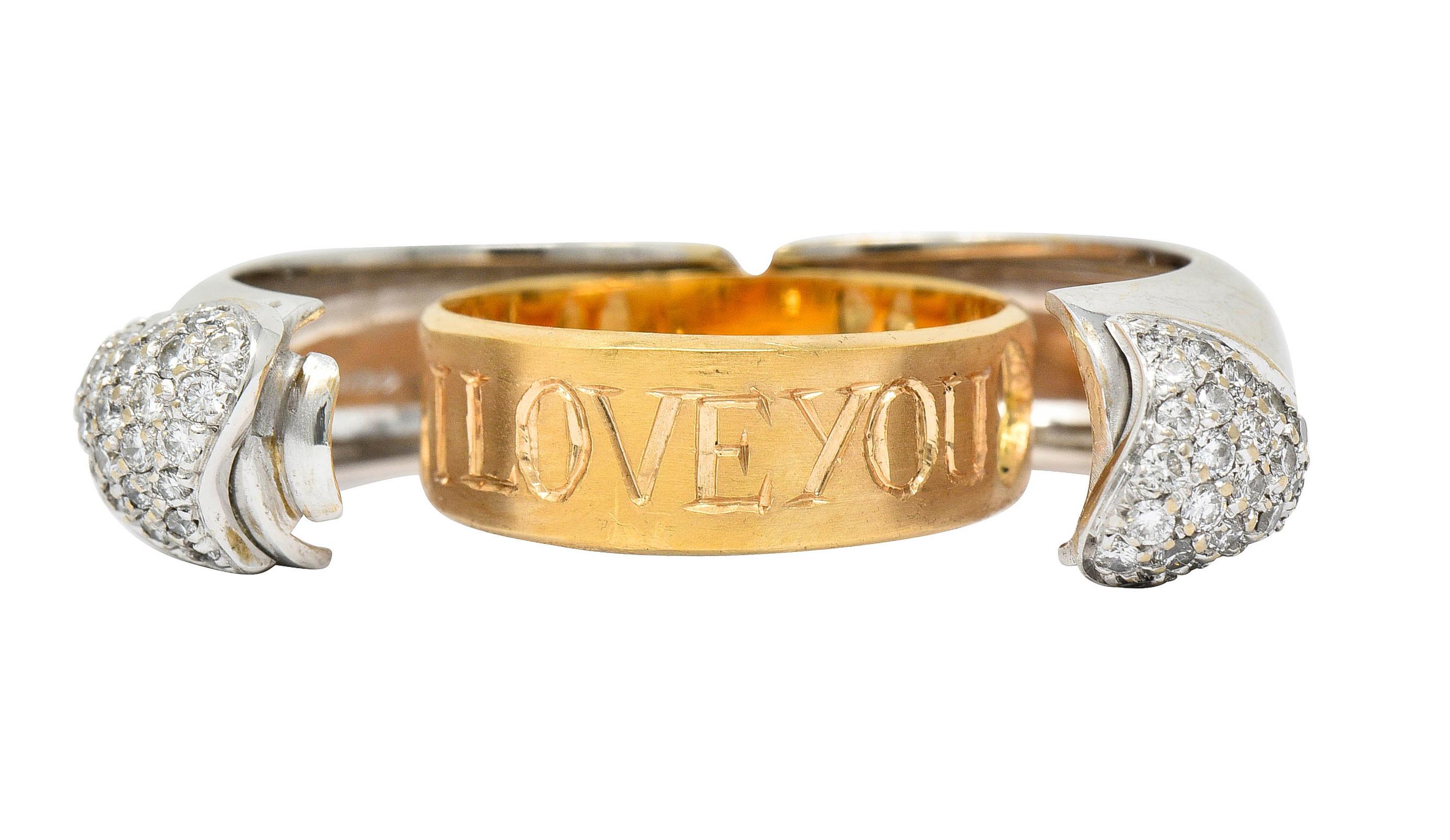 Puffed white gold band ring centers two interlocking pavè diamond hearts

Round brilliant cut diamonds weigh approximately 0.50 carat total - eye clean and white

Opens on a hinge to reveal a hidden inner gold band - pierced with hearts and engraved