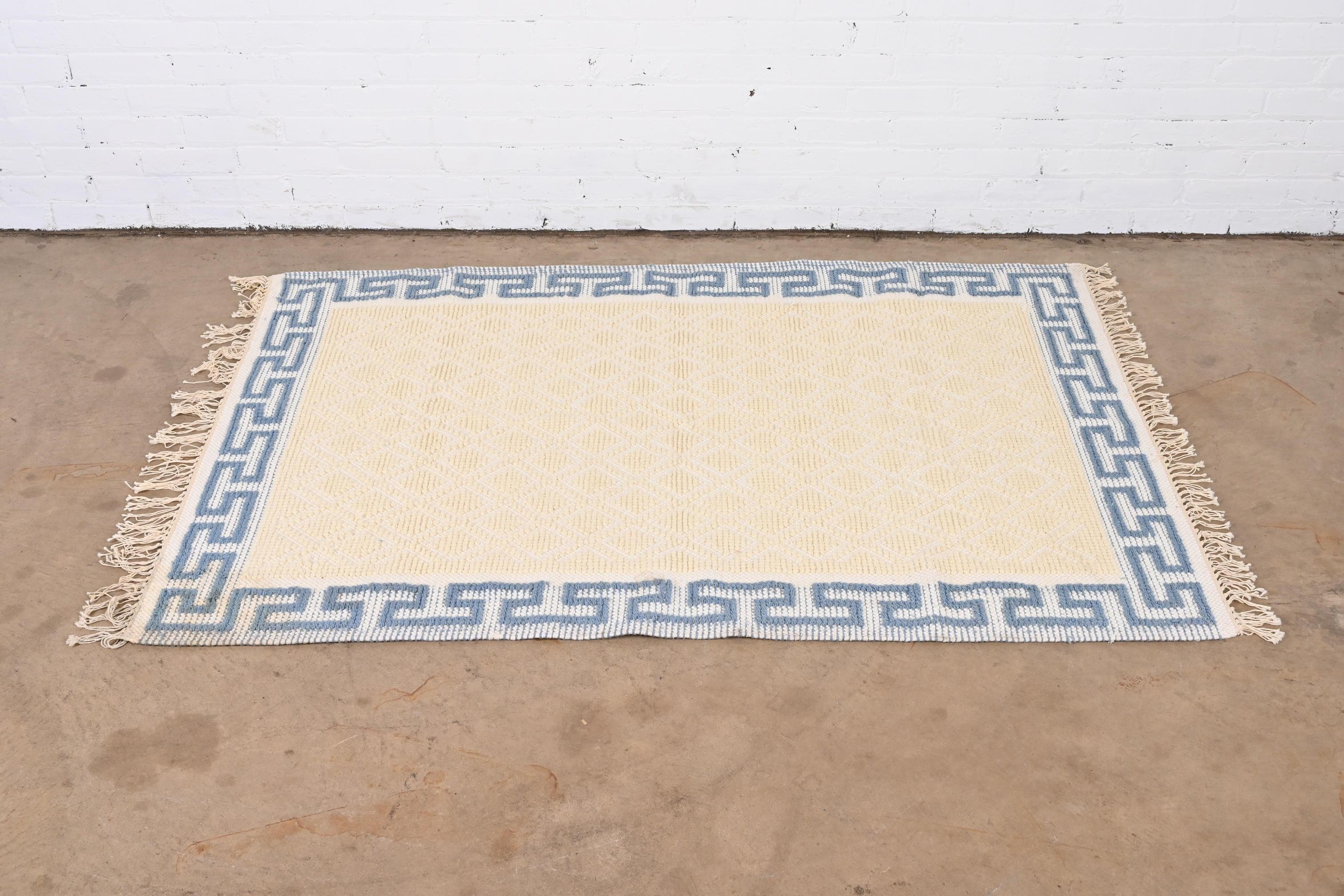 A stylish vintage 4x6 cream and light blue rug with Greek Key design on the border

Late 20th Century

Measures: 46
