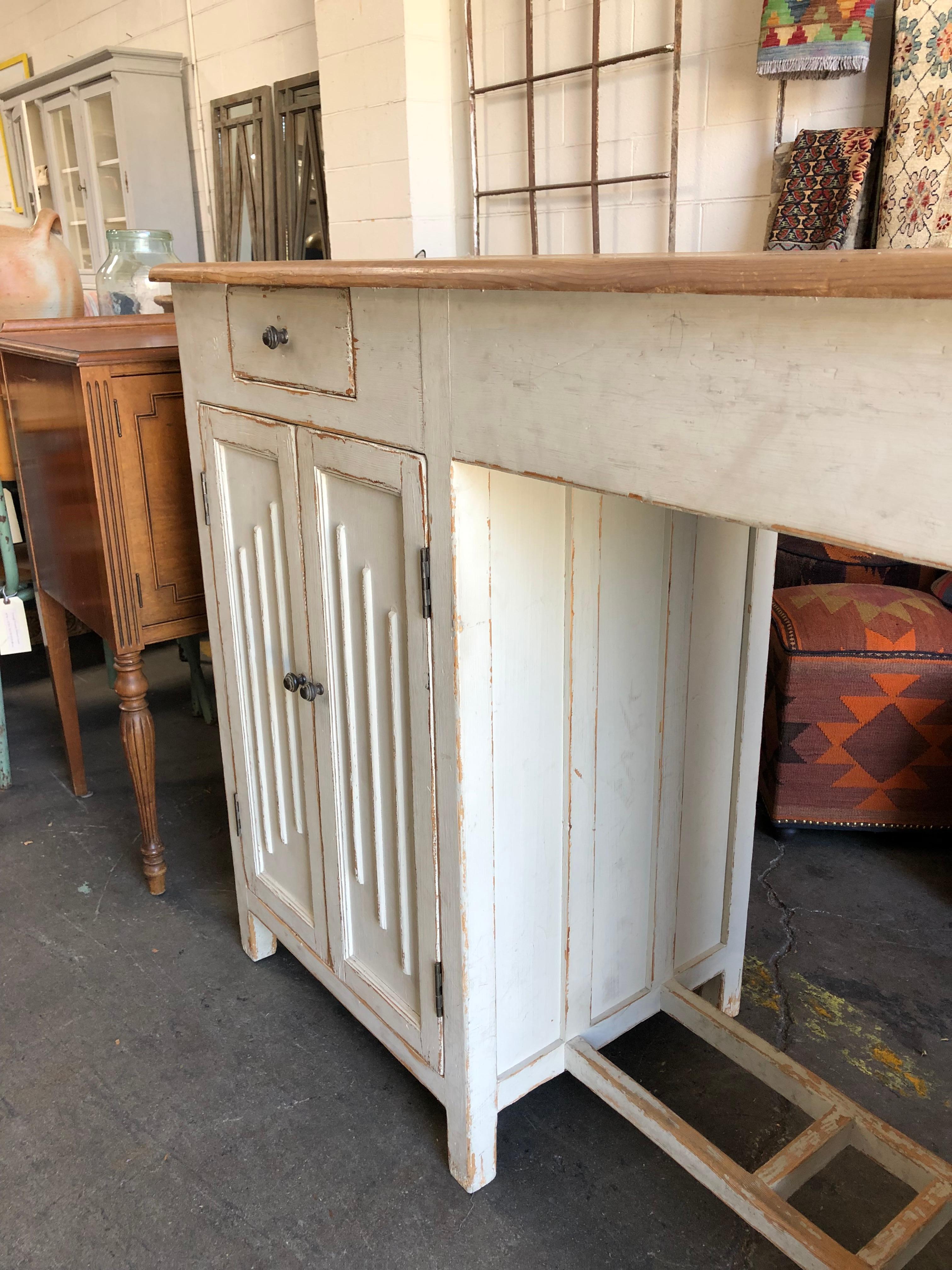 Classic distressed eggshell painted cabinet. Equipped with two working drawings and two pairs of working cabinet doors.