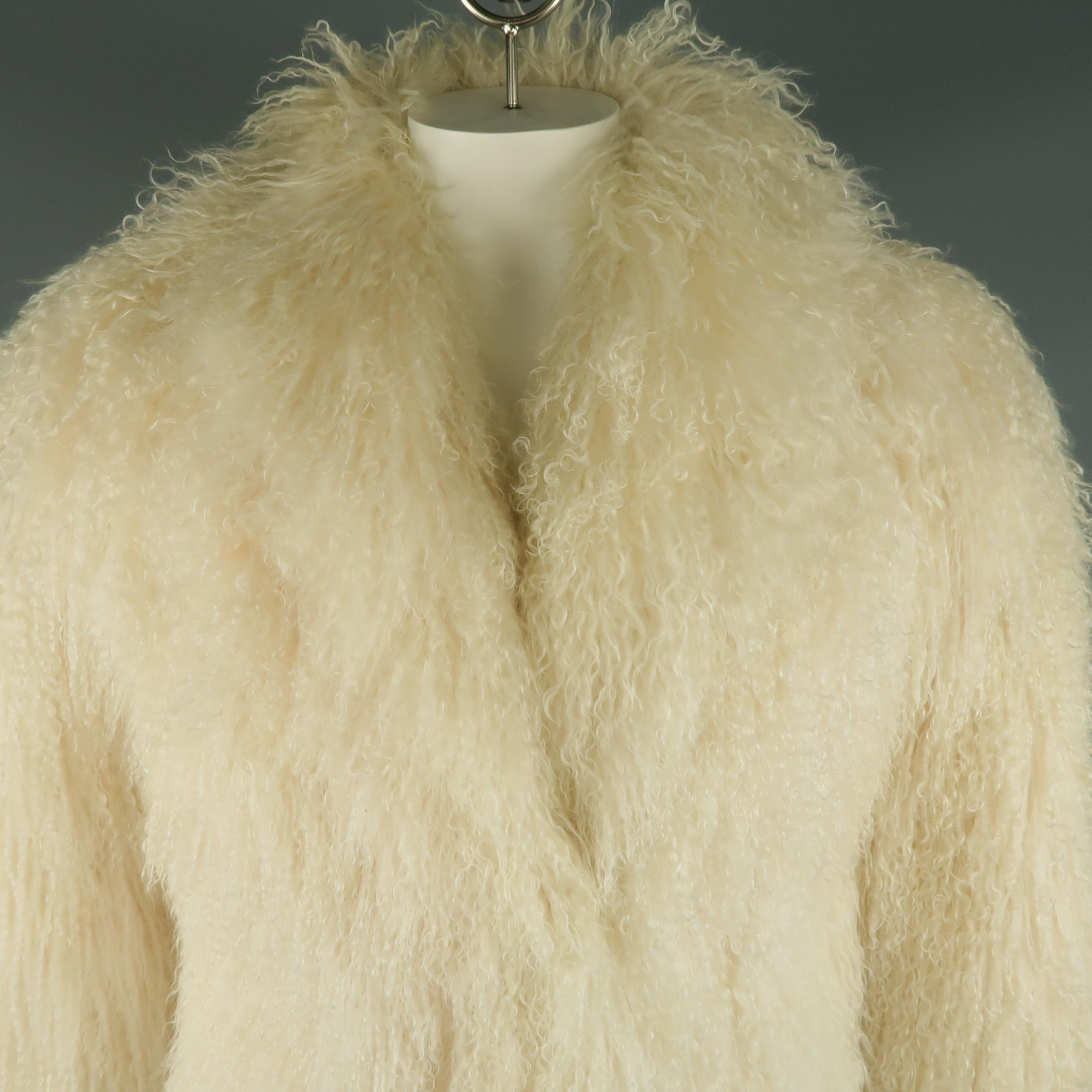 Vintage Mongolian lamb fur coat comes in a gorgeous light cream color with a round shawl collar, slit pockets, and asymmetrical single hook eye closure. Very minor wear.
 
Good Pre-Owned Condition.
Marked: S
 
Measurements:
 
Shoulder: 19 in.
Chest: