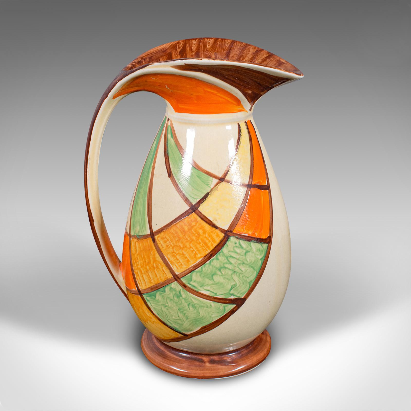 
This is a vintage cream pouring jug. An English, hand painted ceramic decorative server in Art Deco taste, dating to the early 20th century, circa 1930.

Delightful serpentine form with a vibrant colour palette
Displaying a desirable aged patina