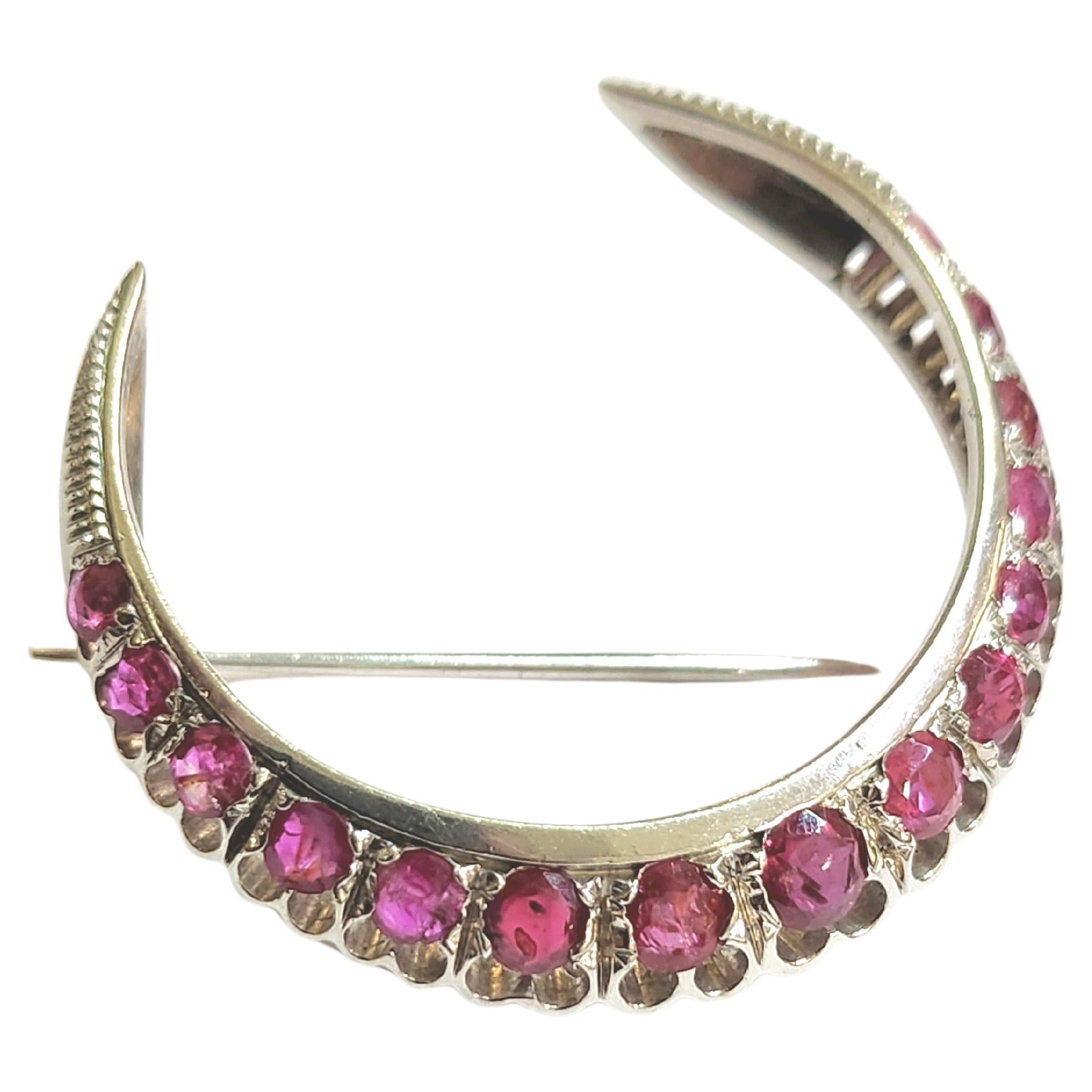 Vintage 18k white gold brooch in crescent designe decorted with natural rubies estimate weight of 2 to 2.5 carats hall marked 750 gold standard in very fine workmanship