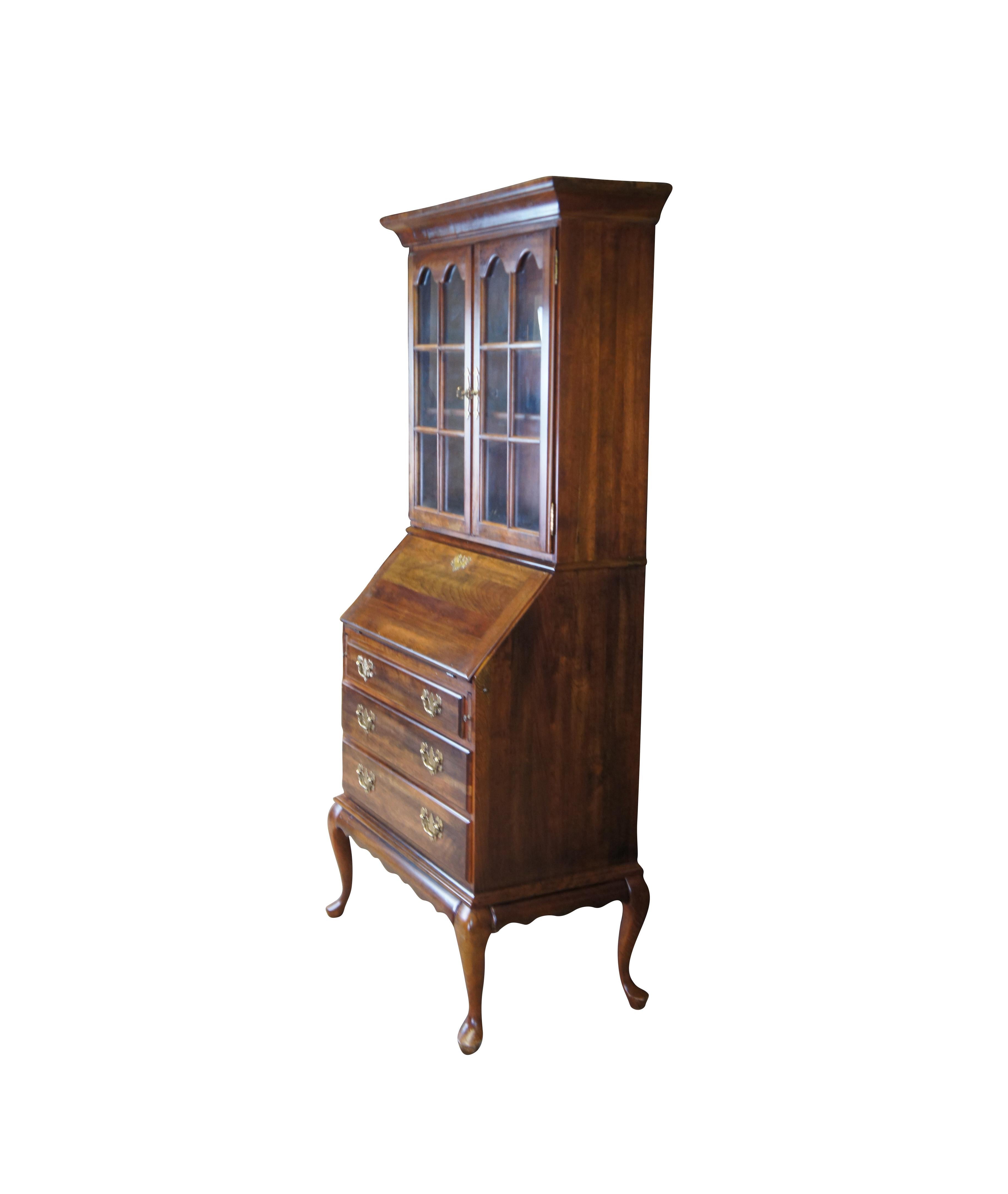 Beautiful Queen Anne style secretary desk and bookcase by Cresent Manufacturing Company, circa 1970s. Made from cherry with a natural distressed finish. Features an upper bookcase with two shelves and lattice covered glass doors with an arched