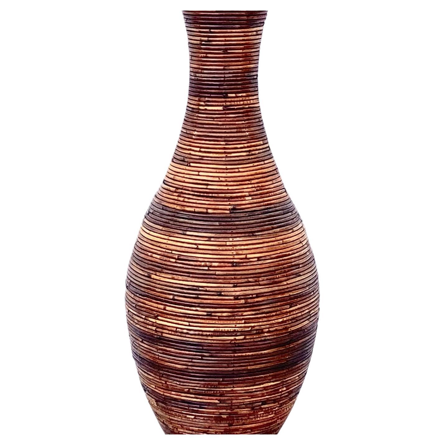 Large mid-century modern hand-crafted pencil reed floor vase in the style of Gabriella Crespi.  Features variegated brown finish. The inside top is lined with black fabric, the bottom is wood. Reed is in very good condition. Can use as a holder for