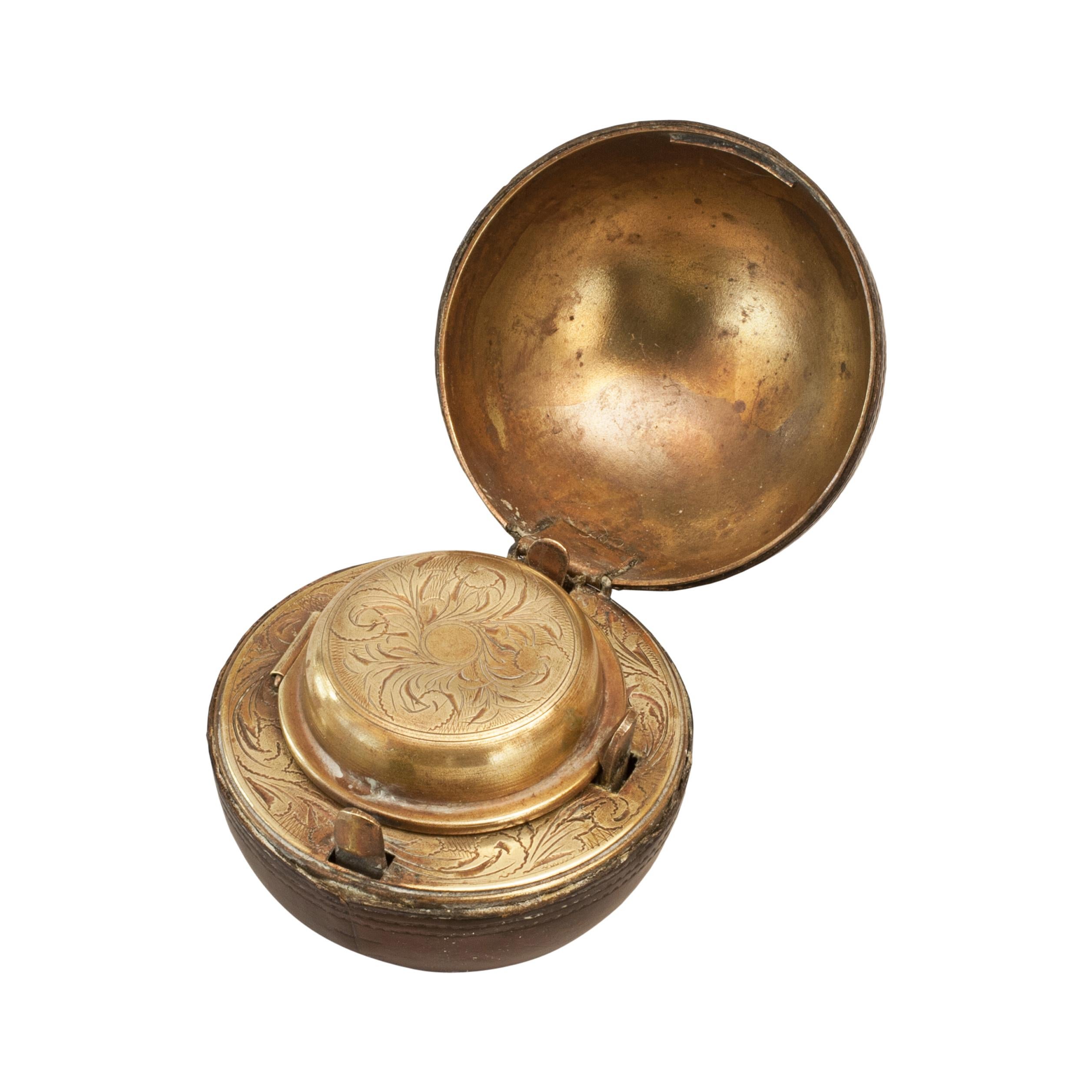 Rare Novelty Cricket Inkwell.
A wonderful leather covered traveling inkwell in the shape of a cricket ball. This is a very desirable, rare and unusual object made from brass and covered in imprinted leather to imitate a ball. It is hinged in the