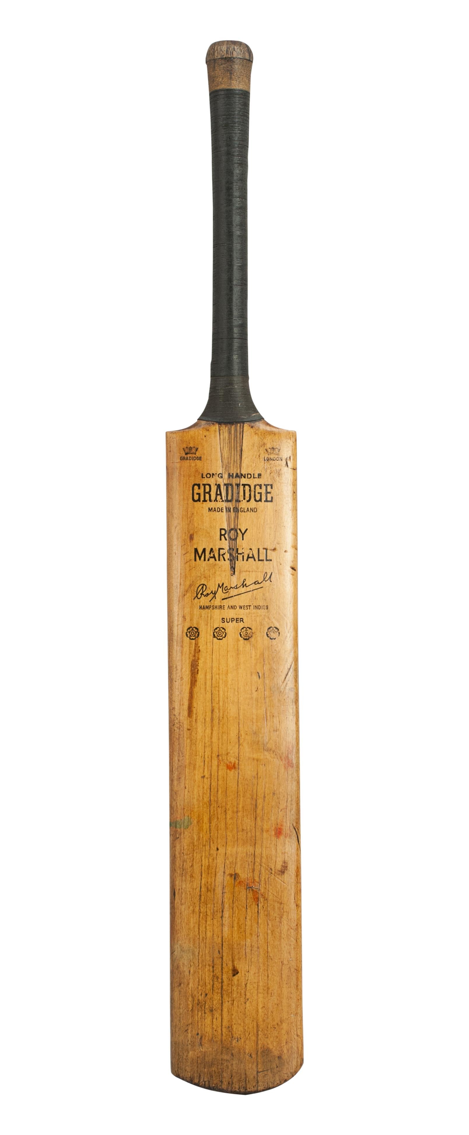 A good willow cricket bat by Gradidge of London. The 'Roy Marshall' autograph bat is in good condition with a lovely patina. The blade is embossed with a crown on each shoulder, the words 'Gradidge' under one, 'London' under the other. Also 'Long