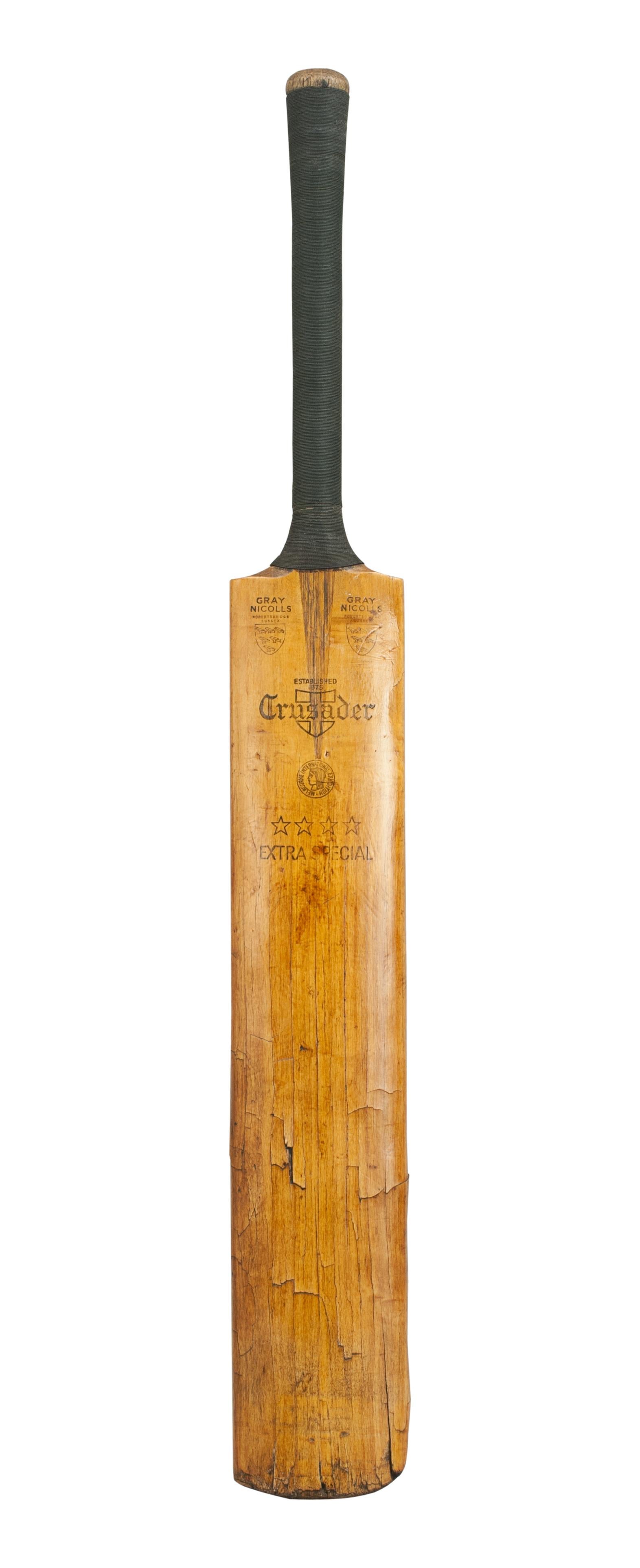 A fine gray Nicolls cricket bat 'Crusader'. The bat is in good condition with new cord grip. The shoulders are embossed 'Gray Nicolls' with the Nicolls trade mark shield with the words 'Robertsbridge Sussex'. Also embossed on the blade of the bat is