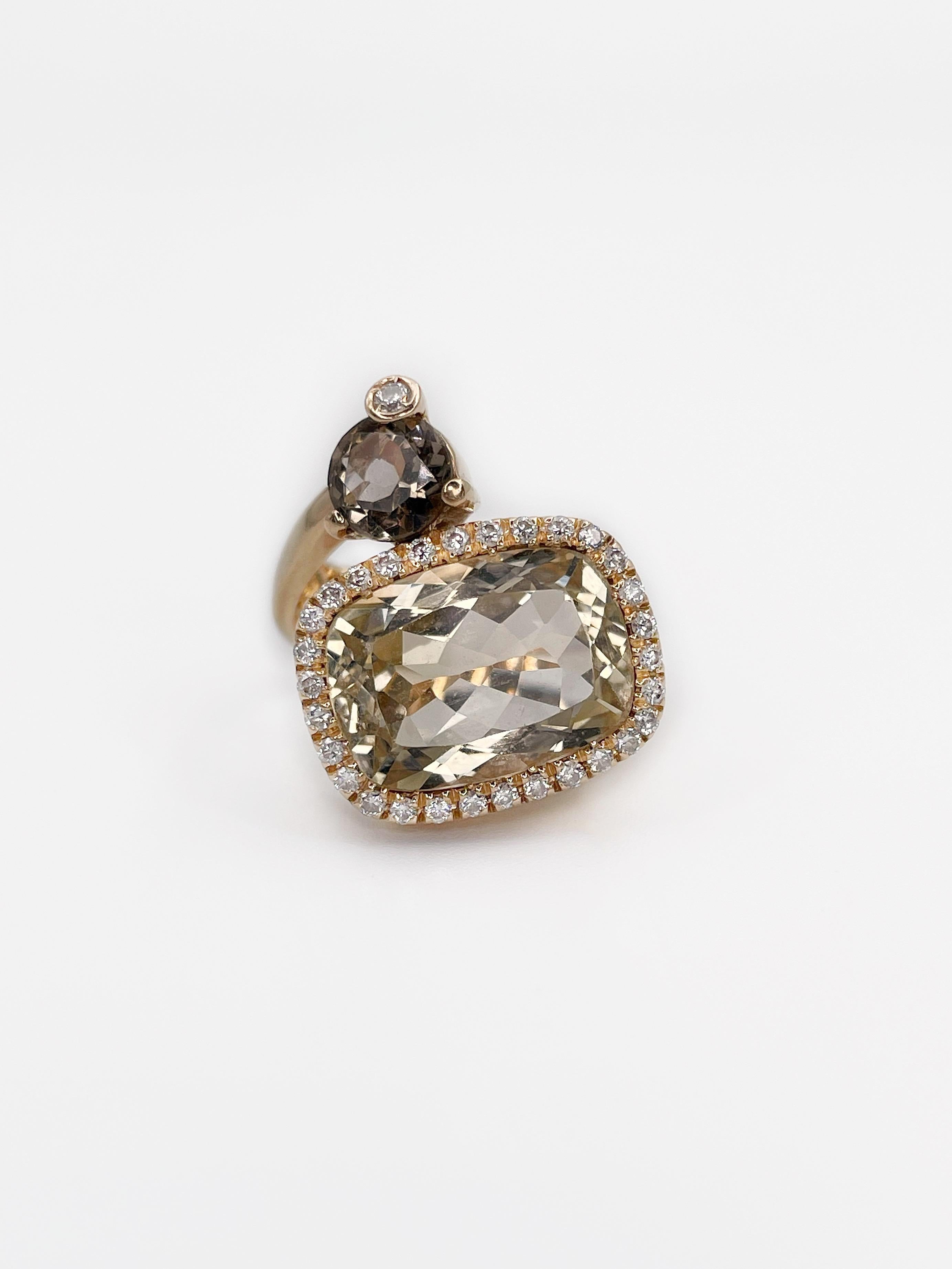 This artsy ring is made by Italian brand Criso. It is in yellow 18K gold and features two different shapes stones. Rectangle citrine is surounded by 30 round brilliant cut diamonds. Round smoky quartz is accompanied with one brilliant cut diamond.