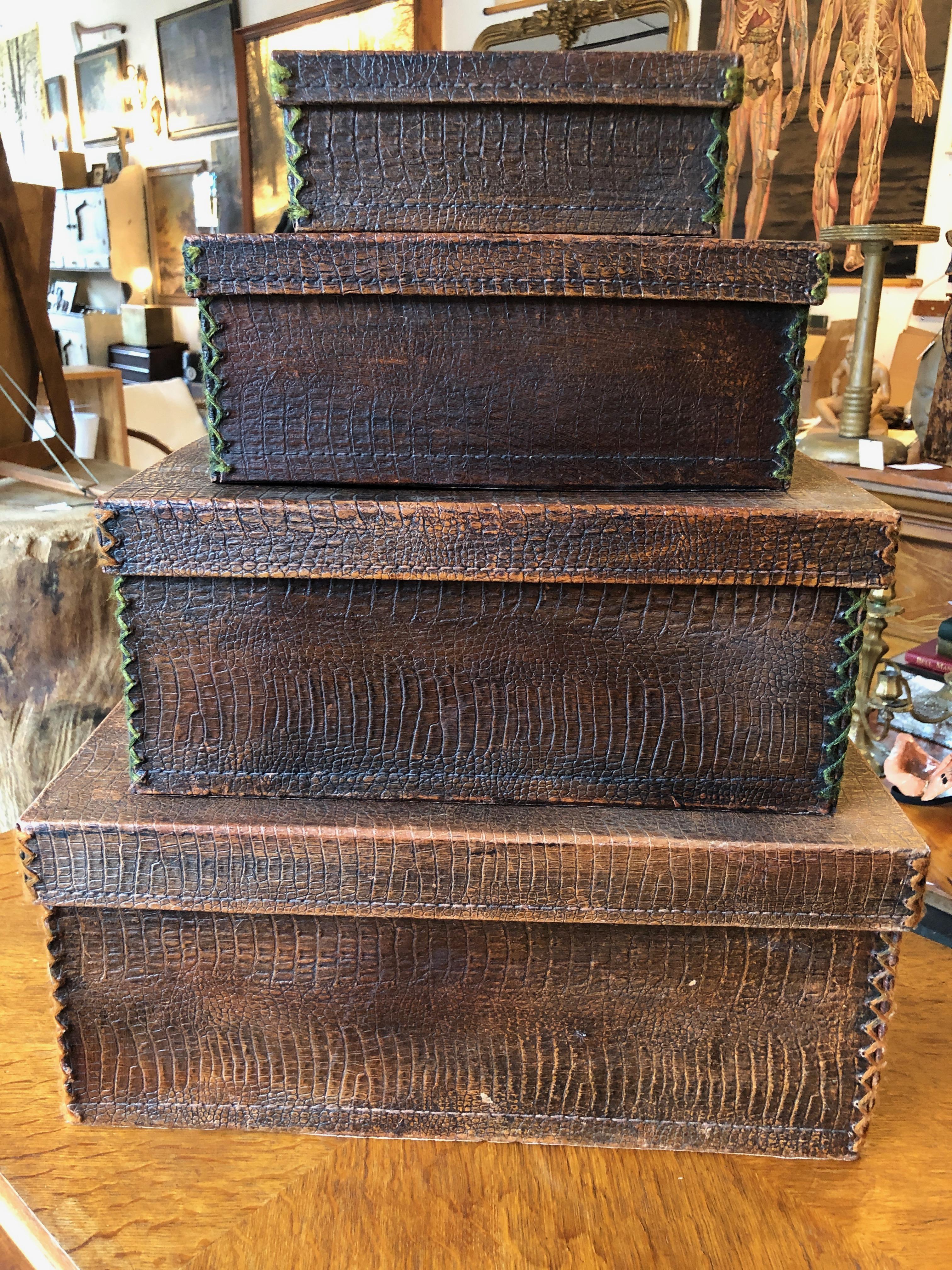 This is a lovely set of four velvet lined crocodile skin nesting boxes, circa 1940. The corners of the lids and boxes have a green and orange stitch detail. Perfect for the library, study, or closet. Listed measurements are for the largest box. The