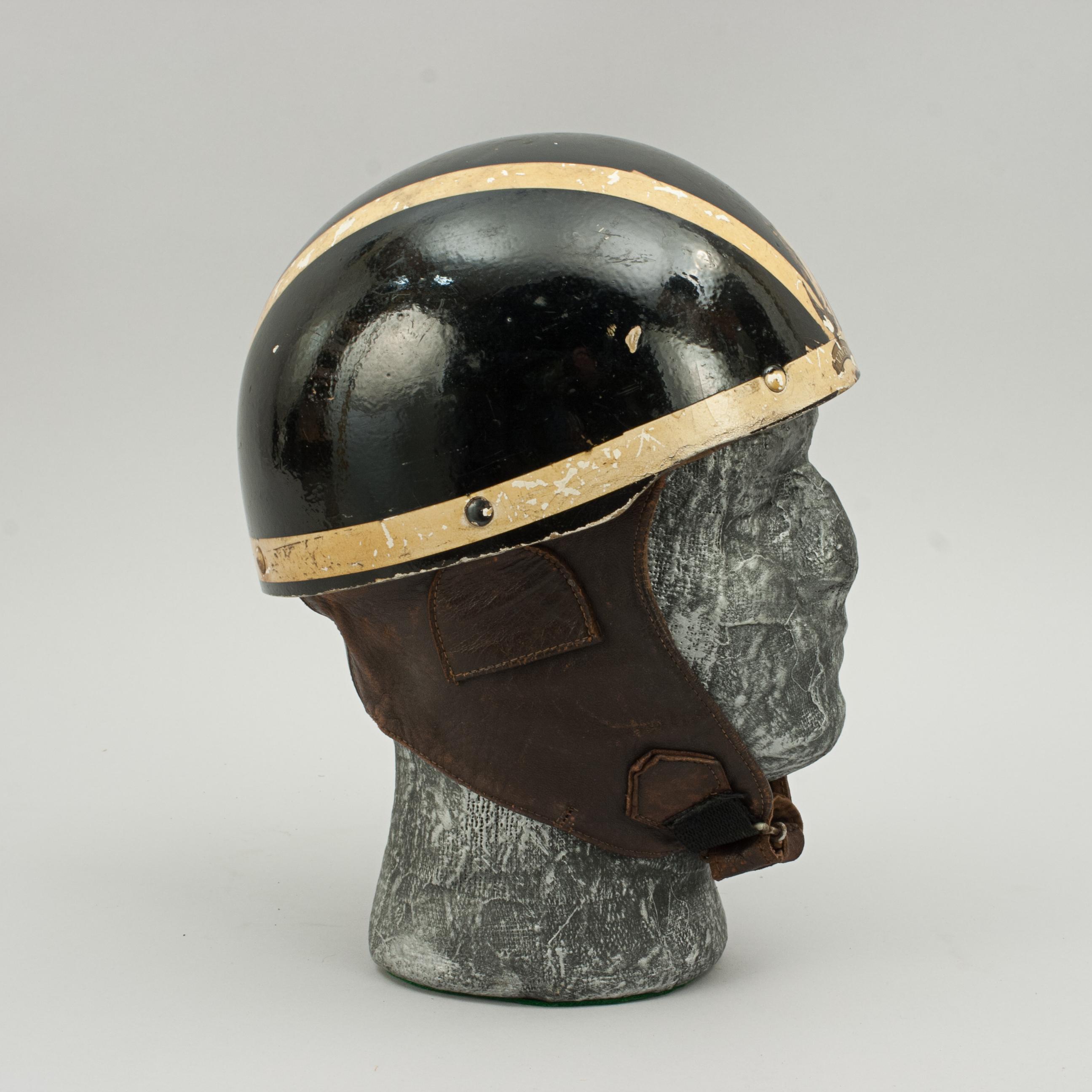 Vintage Cromwell Motorcycle helmet, The 'Noll'.
A black helmet made in England by Cromwell, The 'Noll'. The pudding basin motorcycle helmet is fitted with a material headband and straps keeping a space between the head and outer case of the helmet.