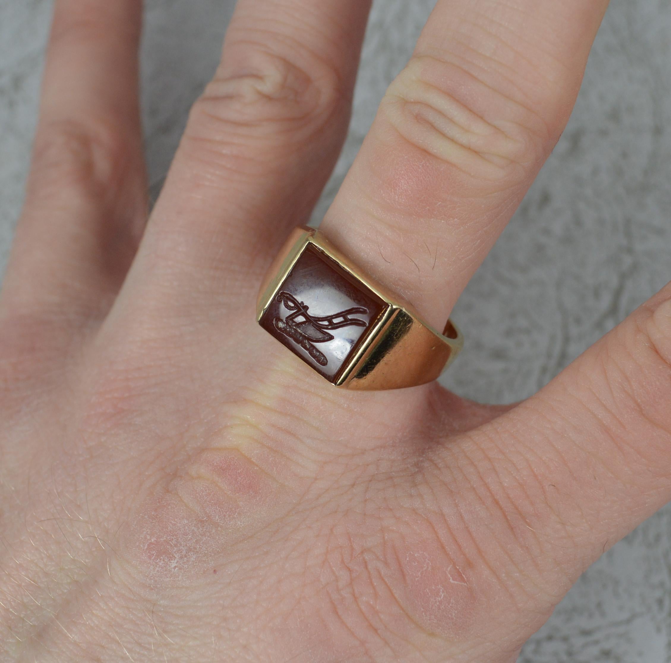 A superb vintage signet ring by Cropp and Farr.
Solid 9 carat yellow gold example with a single carnelian to centre.
A square shaped stone to centre, 10.5mm x 10.5mm. Engraved with a farmers plough to centre.

CONDITION ; Good for age. Clean and