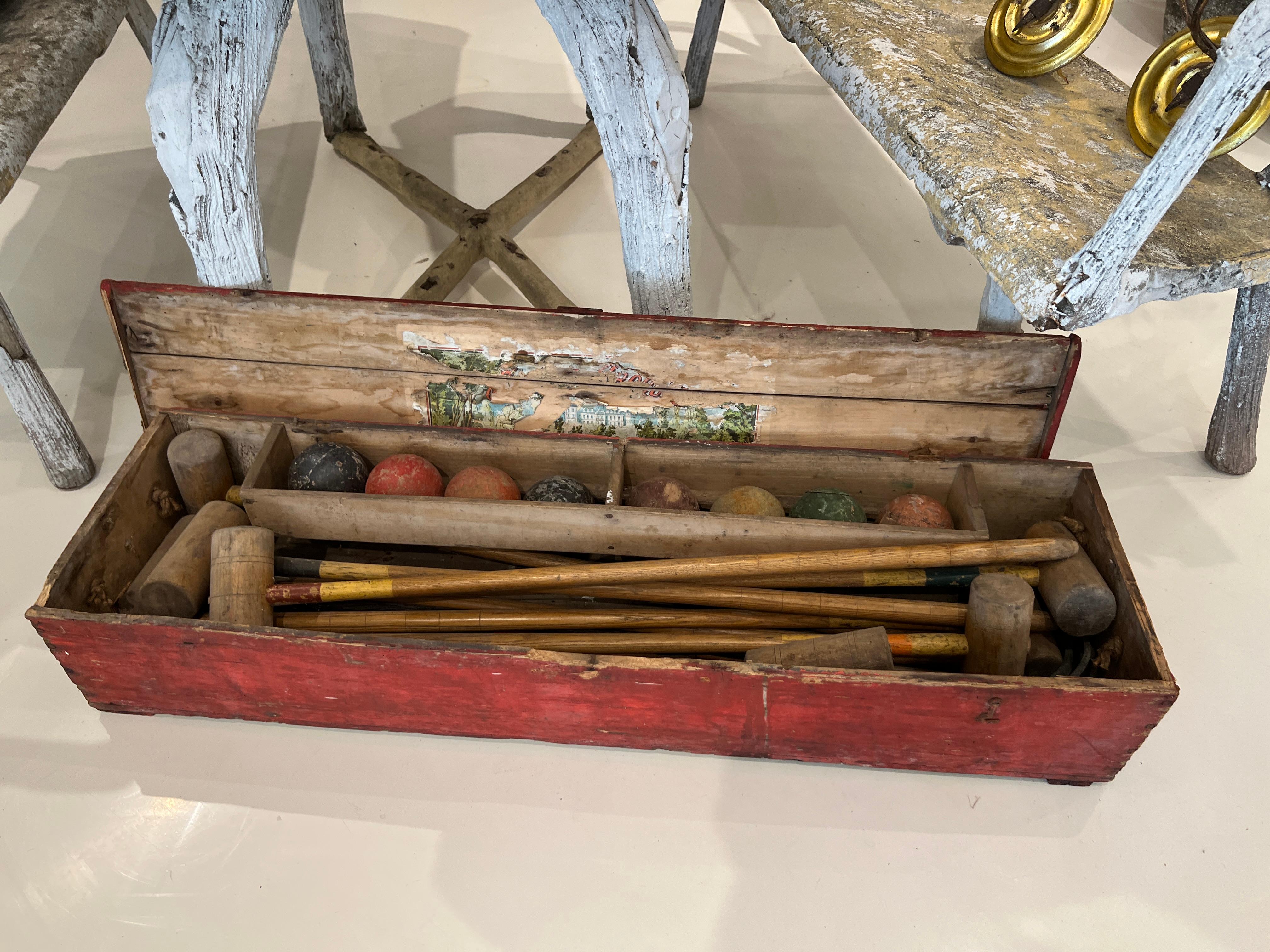 Vintage croquet set with original box and interior label. Spectacular set filled with family memories.

Wear consistent with age and use. Some loss to finish and label.