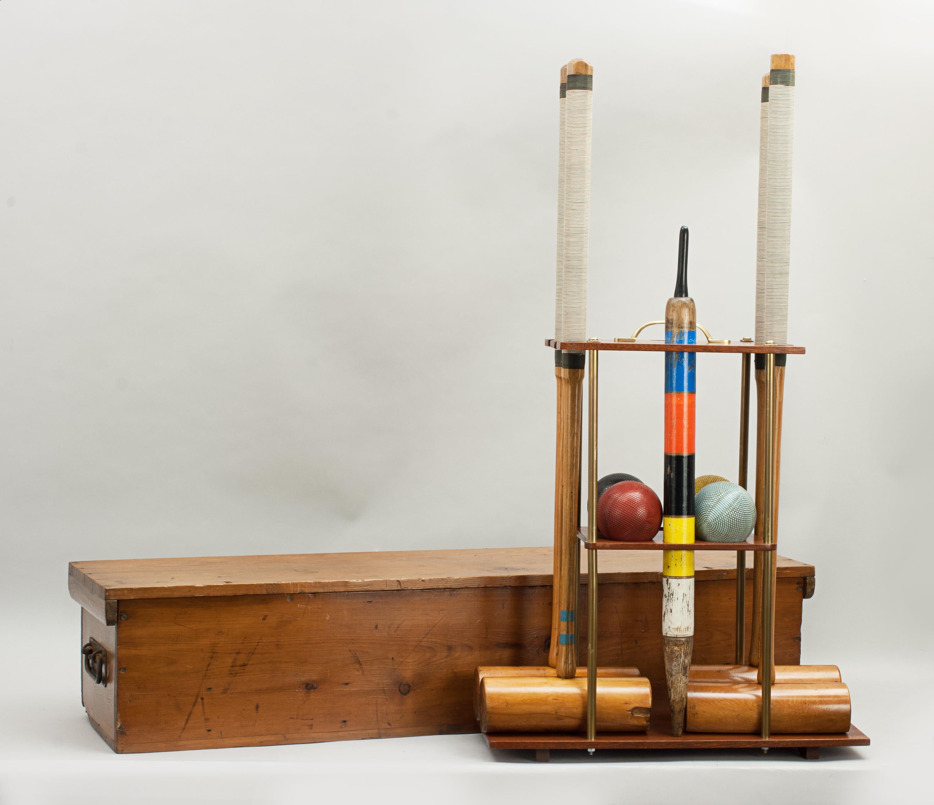 Vintage croquet set in pine box.
A four mallet croquet set on a mahogany stand and with a polished pine box. Three of the mallets are stamped 'A & N.C.S.L', which stands for Army and Navy Co-Op Society Ltd, and the forth is stamped 'THE PEEL'