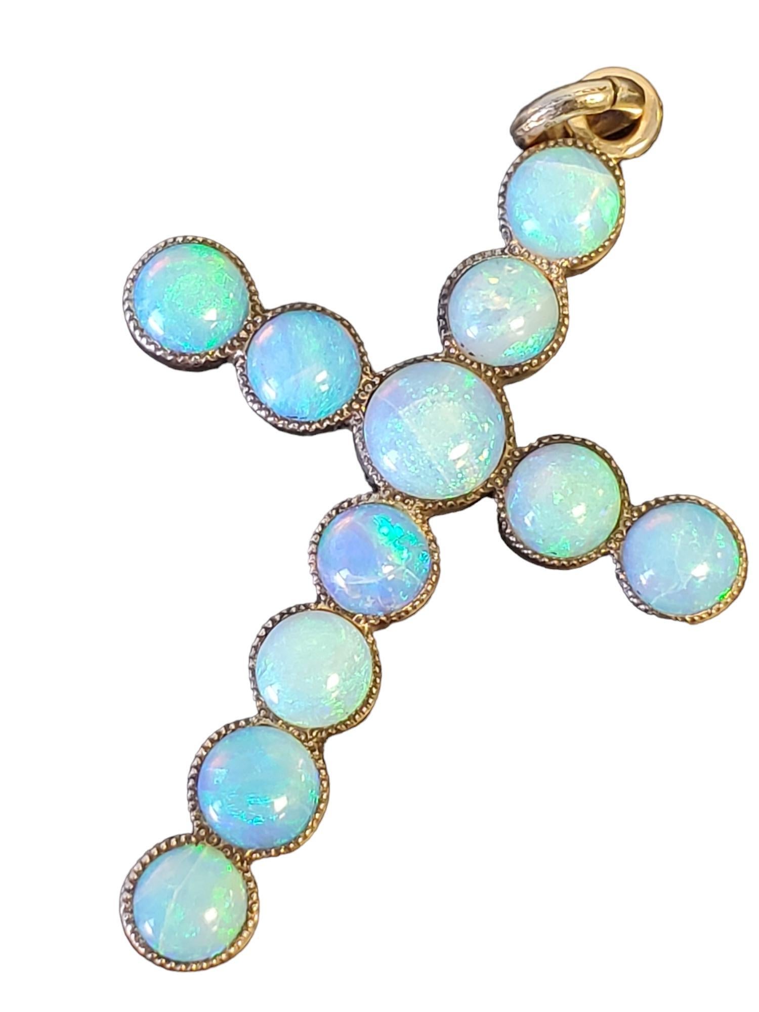Listed is a vintage 10k gold opal cross pendant. It is large and the opals are spectacular blue color while being very uniform in the piece, this is a feat for natural opals. The length is 2.25