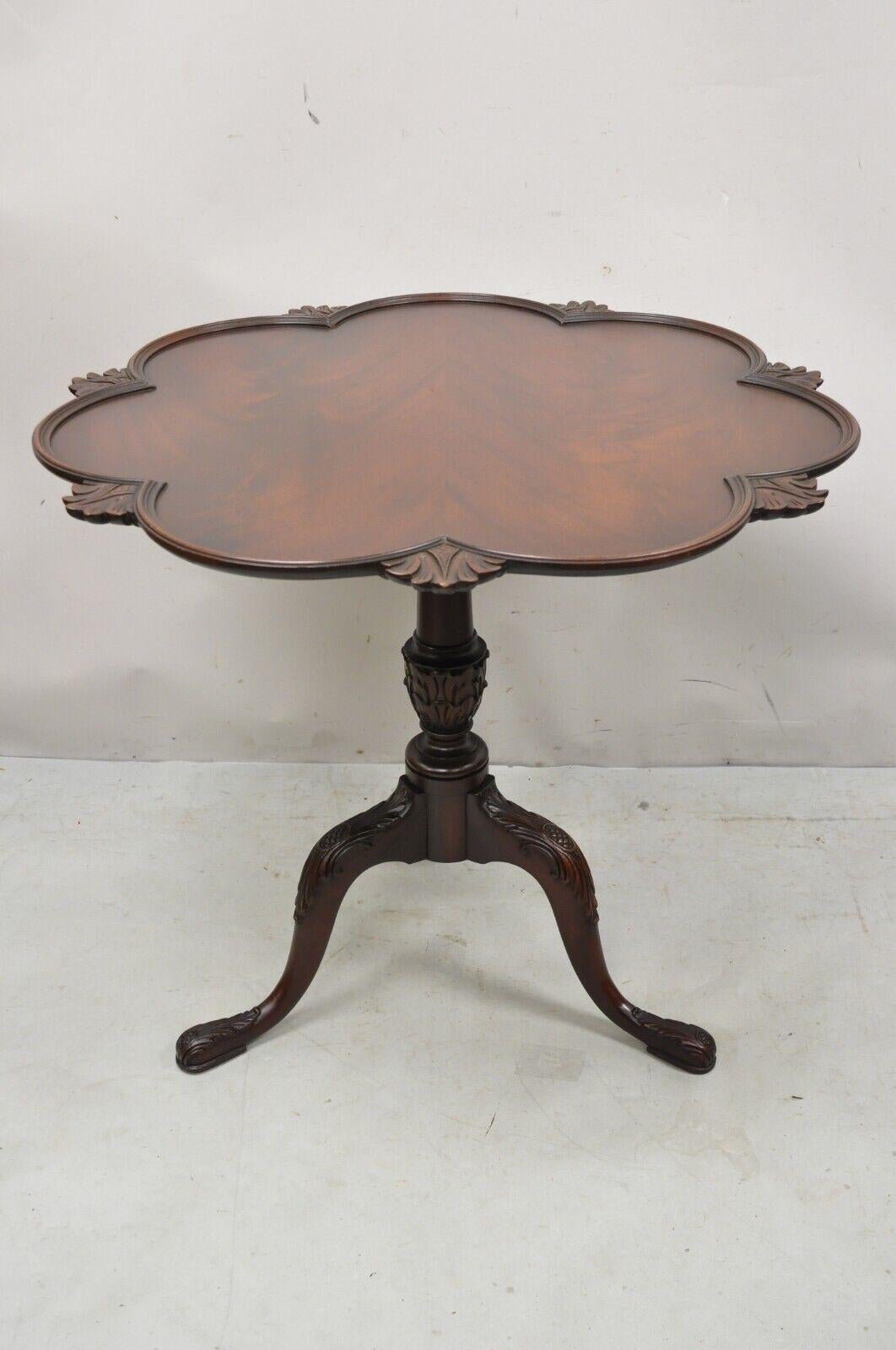Vintage Crotch Mahogany Chippendale style Pie Crust pedestal side tea table. Item features a carved pedestal base, scalloped top, carved accents, beautiful wood grain, very nice antique item, great style and form. Circa Early to mid 20th century.