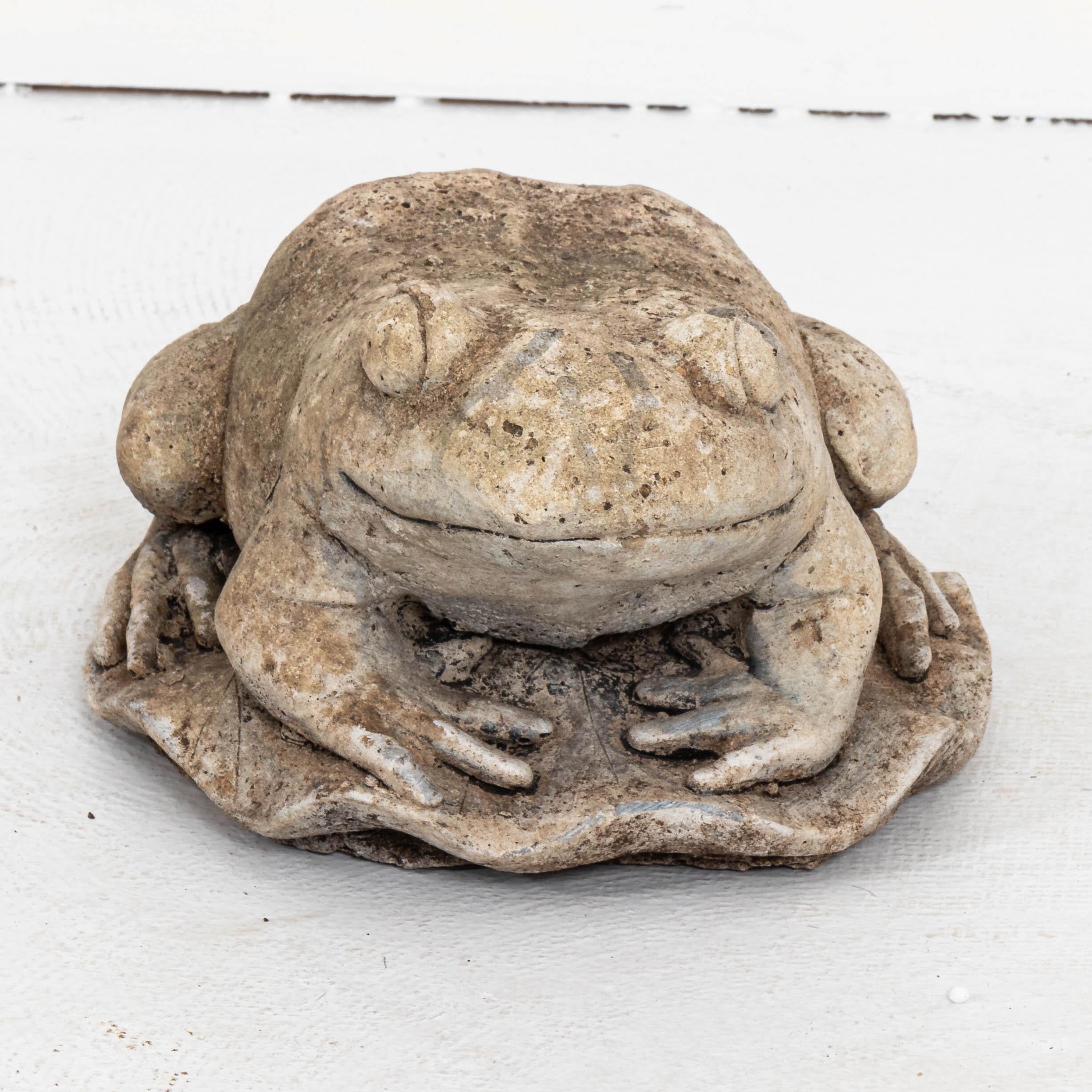 Unique cast stone garden statue in the shape of frog crouching on a leaf. Made in England in the early 20th century, this charming statue a playful element to add to the landscape. Good condition, weathered with age and exposure to the elements.
