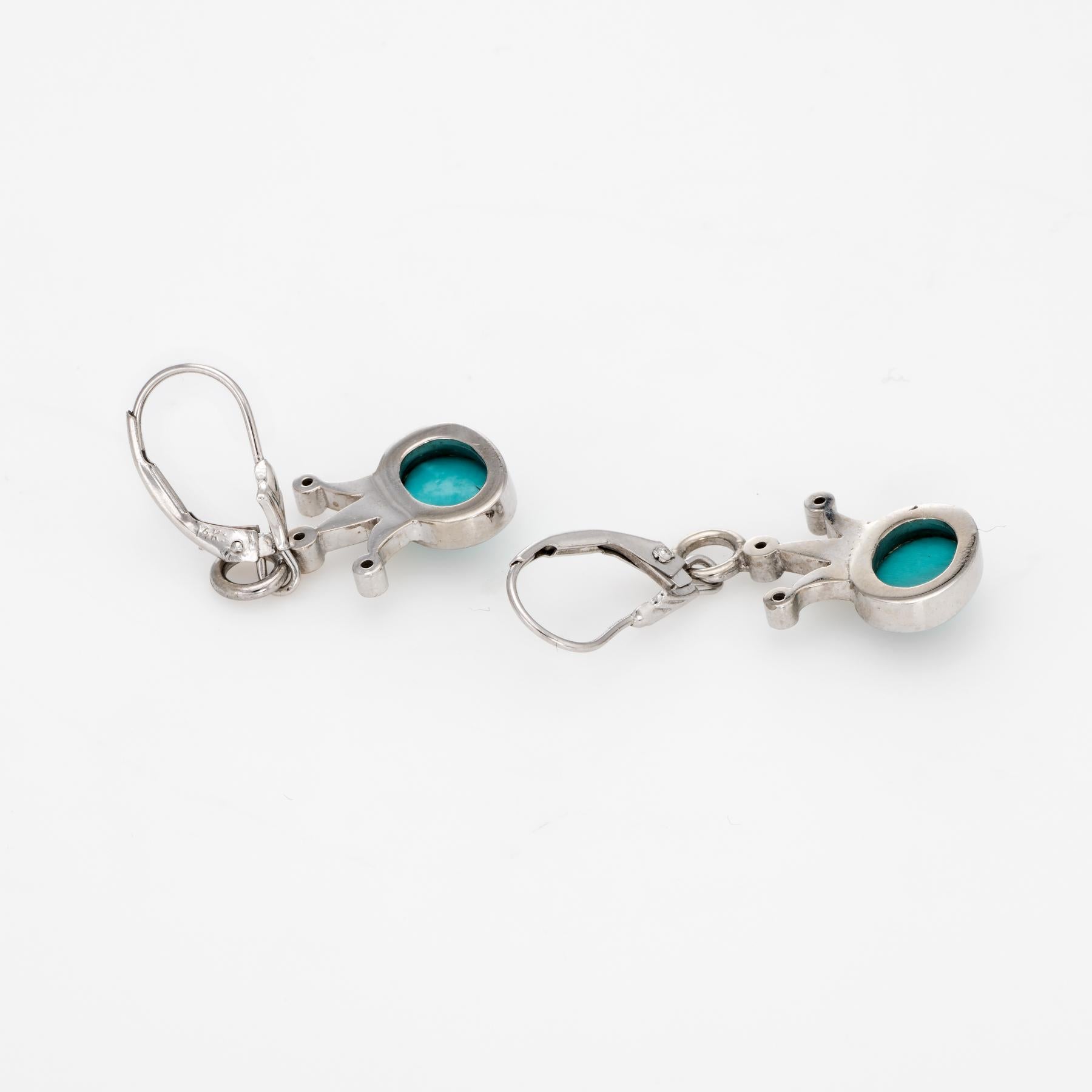 Elegant pair of vintage turquoise & diamond crown earrings, crafted in 14k white gold. 

Cabochon cut turquoise measures 7.5mm x 6mm (each), accented with an estimated 0.10 carats of diamonds (estimated at H-I color and SI2-I1 clarity). The