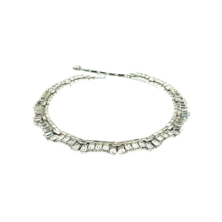 A Vintage Crown Trifari Deco Necklace in a collar style. A stunning example of mid century Crown Trifari craftsmanship oozing Art Deco revival style. Featuring a fabulous array of baguette cut crystal stones in a sectioned rhodium plated metal