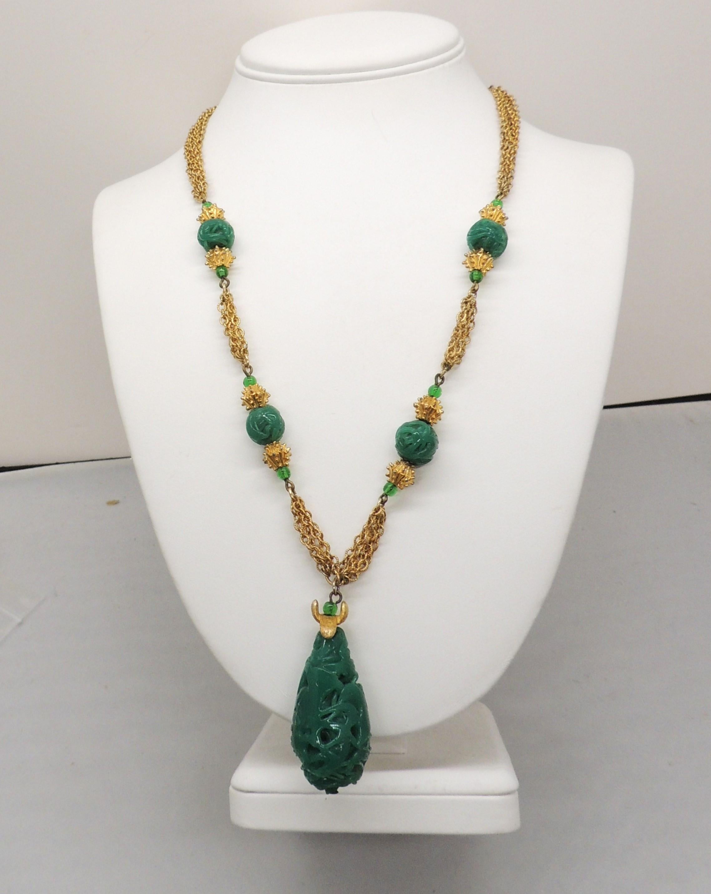 Circa 1960s faux-pade pendant drop with four bigger faux-jade drops with spiky goldtone beads and small green glass spacer beads necklace with fold over clasp. Marked 