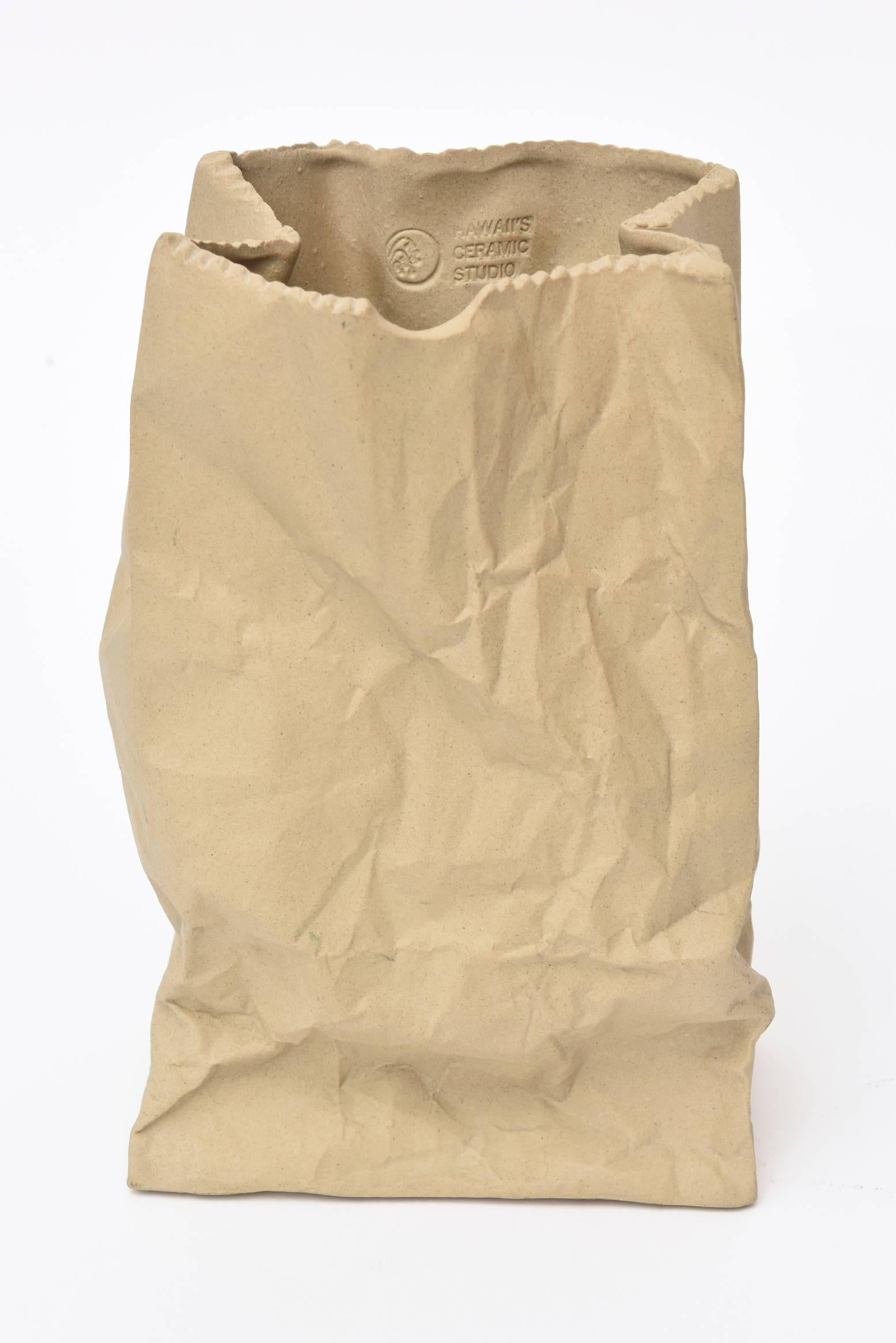 This vintage crushed brown paper bag ceramic sculpture is by a California ceramic company and is from the 1970s.
It is the color of a shopping bag tan.
Just a fun desk accessory or sculpture to any cocktail table. It can also be used as a vase. The