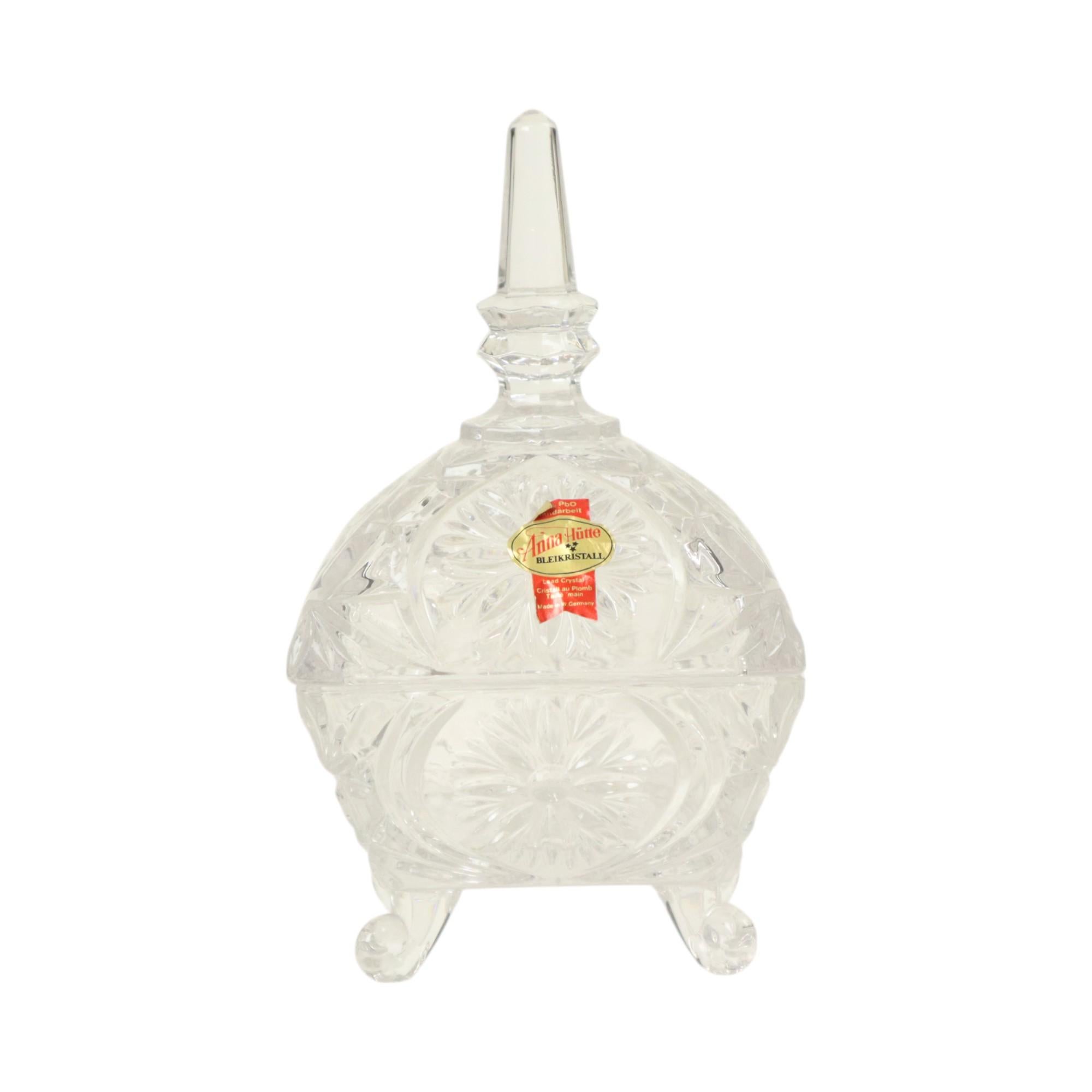 Vintage crystal bonbonniere, candy dish with lid, marked with the makers sticker Anna Hütte, West Germany, 1960s.

Beautiful square geometric pattern, curled legs, floral and star design in relief, very qualitatively made.

In perfect used
