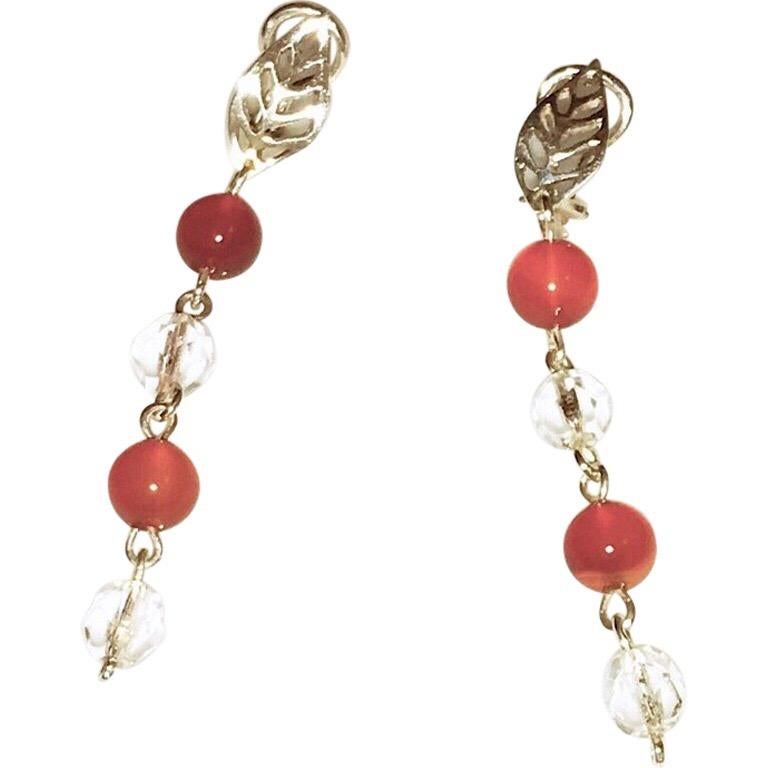 I made this necklace and earring set using carnelian and vintage faceted crystal beads. The matching carnelian and crystal earrings match the dangle and have triptych design and balance. The sterling pierced leaf clips give it a charming designer
