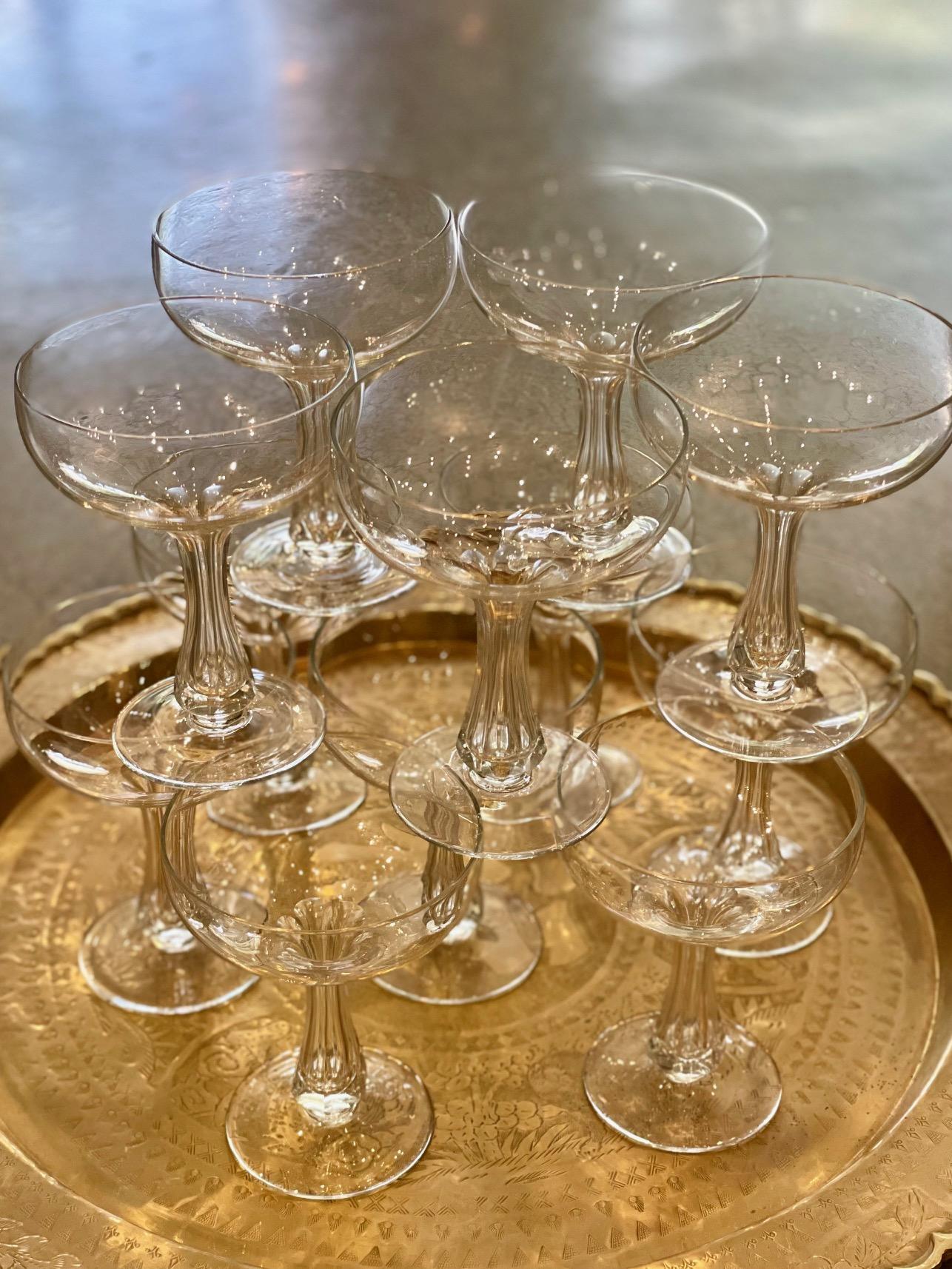We are loving this exceptional set of Vintage Crystal Champagne Coupes. This set of 12 is handmade with memorable hollow and sleek faceted stems. What a way to toast a momentous occasion or celebrate everyday with the most beautiful cut crystal