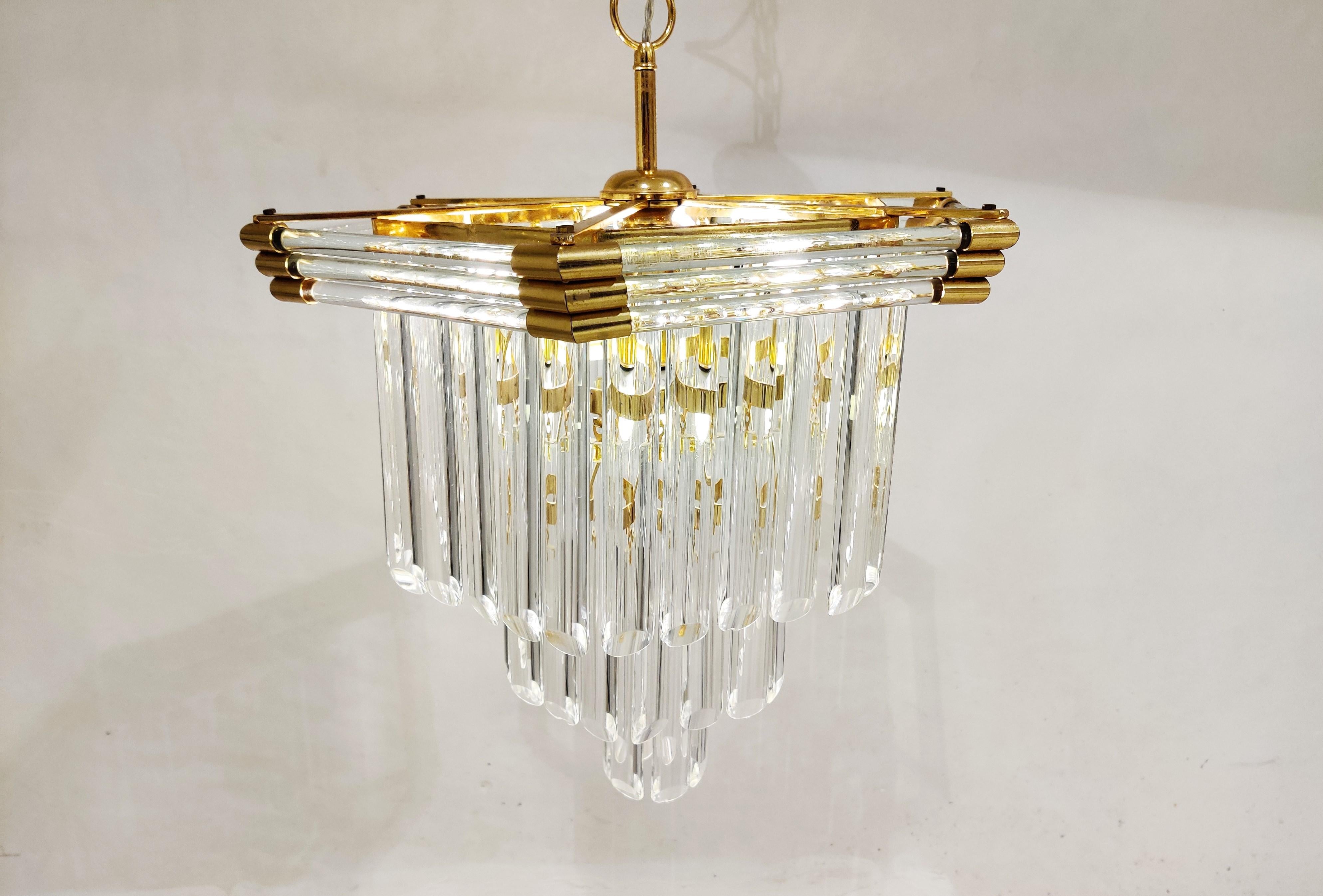 Elegant brass and cut crystal chandelier by Bakalowits & Sohne.

Hexagonal frame with clear glass tubes holding cut glass crystal rods.

The chandelier emits a stunning light.

The lamp is fitted with 3 E27 light sockets.

1980s -