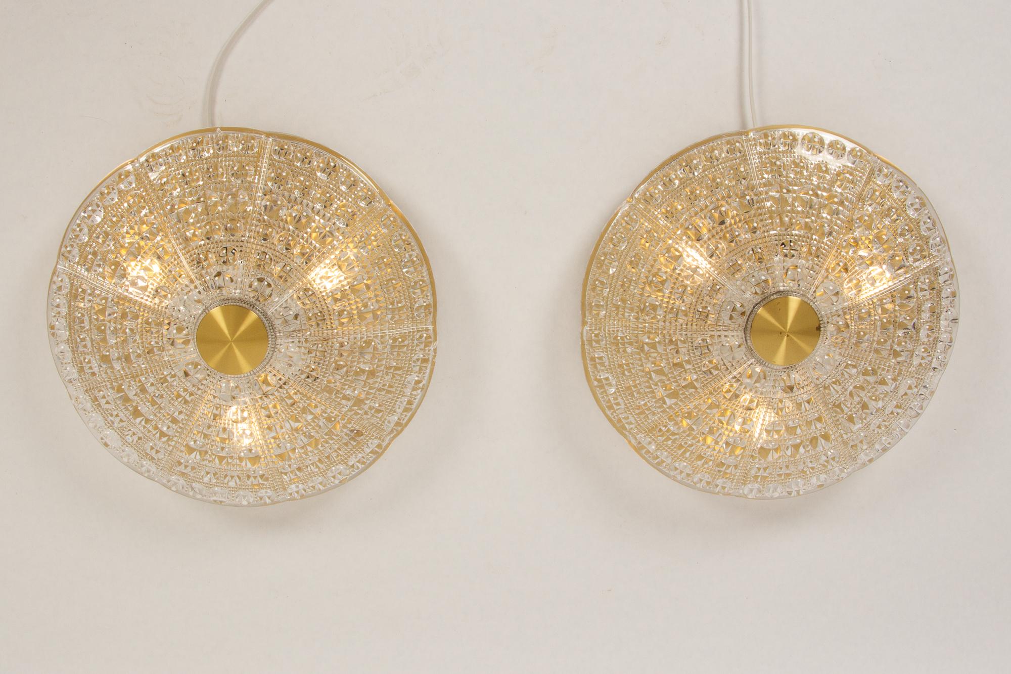Pair of Danish vintage crystal flush mounted ceiling lamps by Carl Fagerlund for Lyfa, 1960s.
Large crystal glass shade from Orrefors mounted on brass plate. Six E14 sockets arranged in a star. For mounting over ceiling or wall outlet.
One small