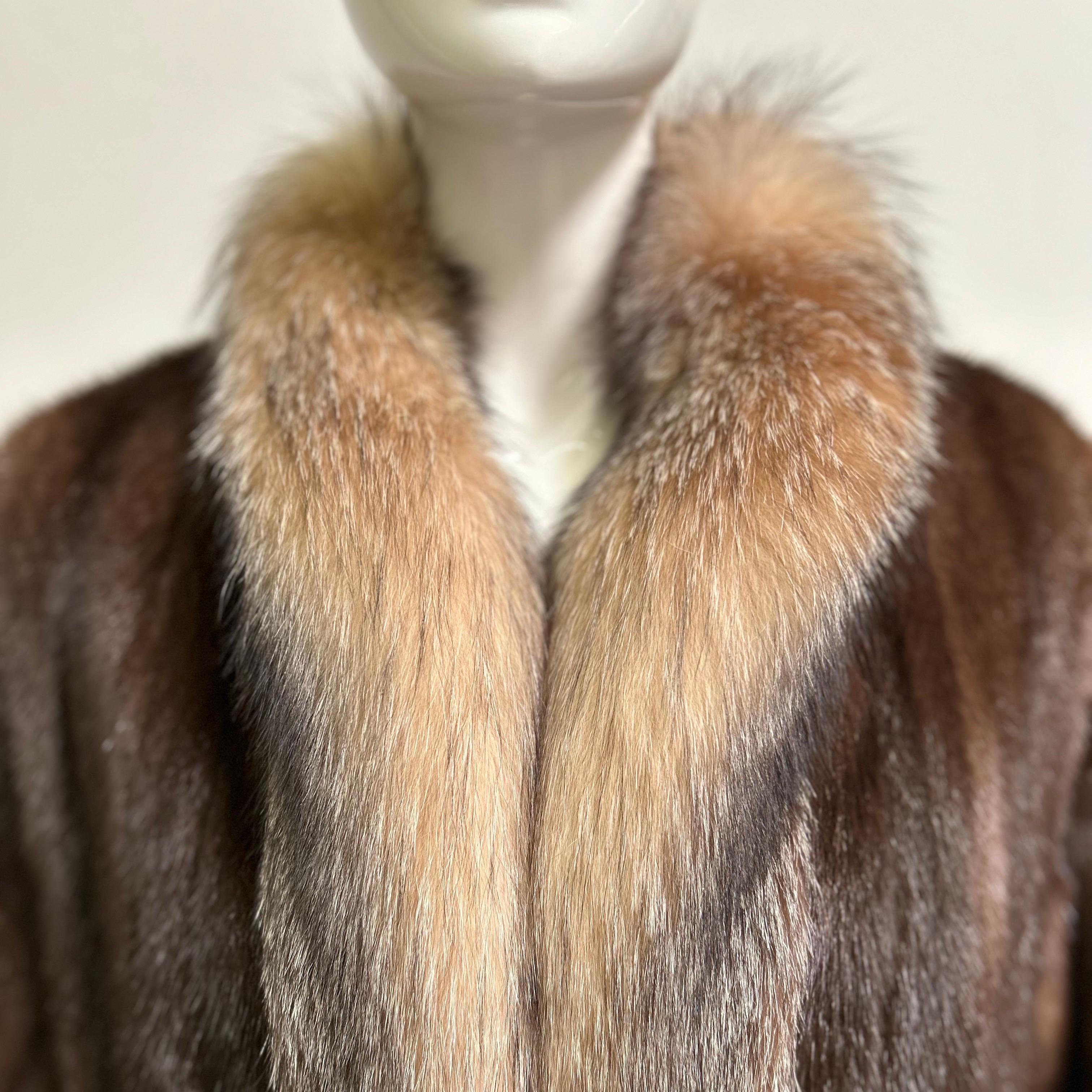Absolutely incredible vintage brown mink fur full length coat with crystal fox fur trim in a size large. Fully lined with front hook closure and monogram. Velvet lined side pockets. Fits a modern size large. The bust measures 44