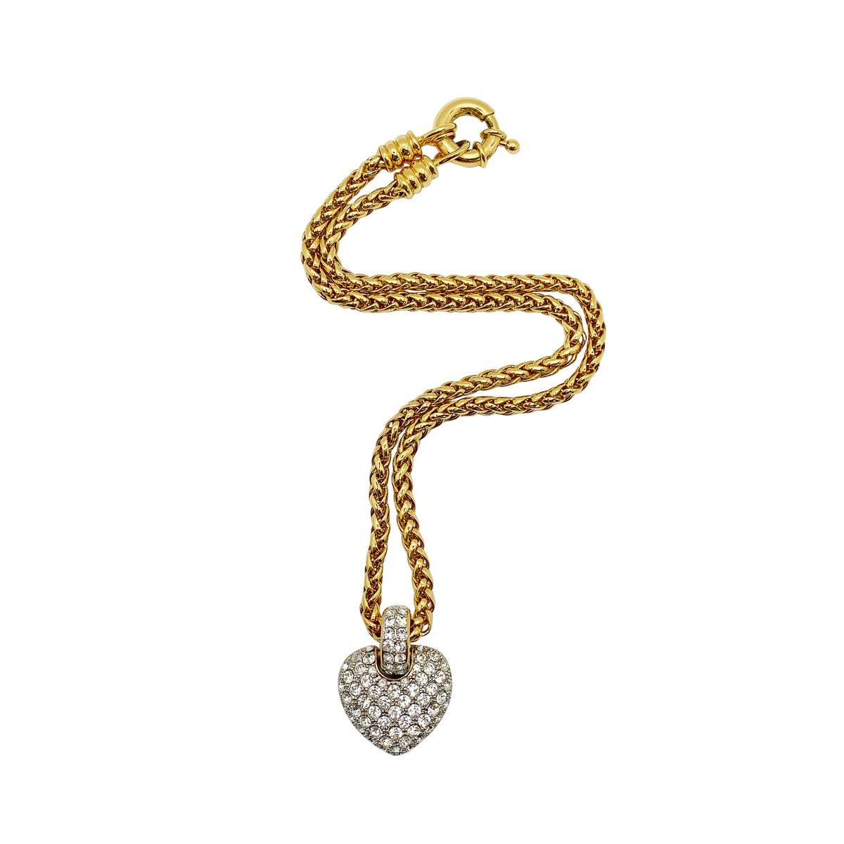 A wonderfully lavish vintage crystal heart necklace. Featuring a chunky wheat link chain with feature bolt ring leading to a large pave crystal heart with matching chunky bale.

Vintage Condition: Very good without damage or noteworthy
