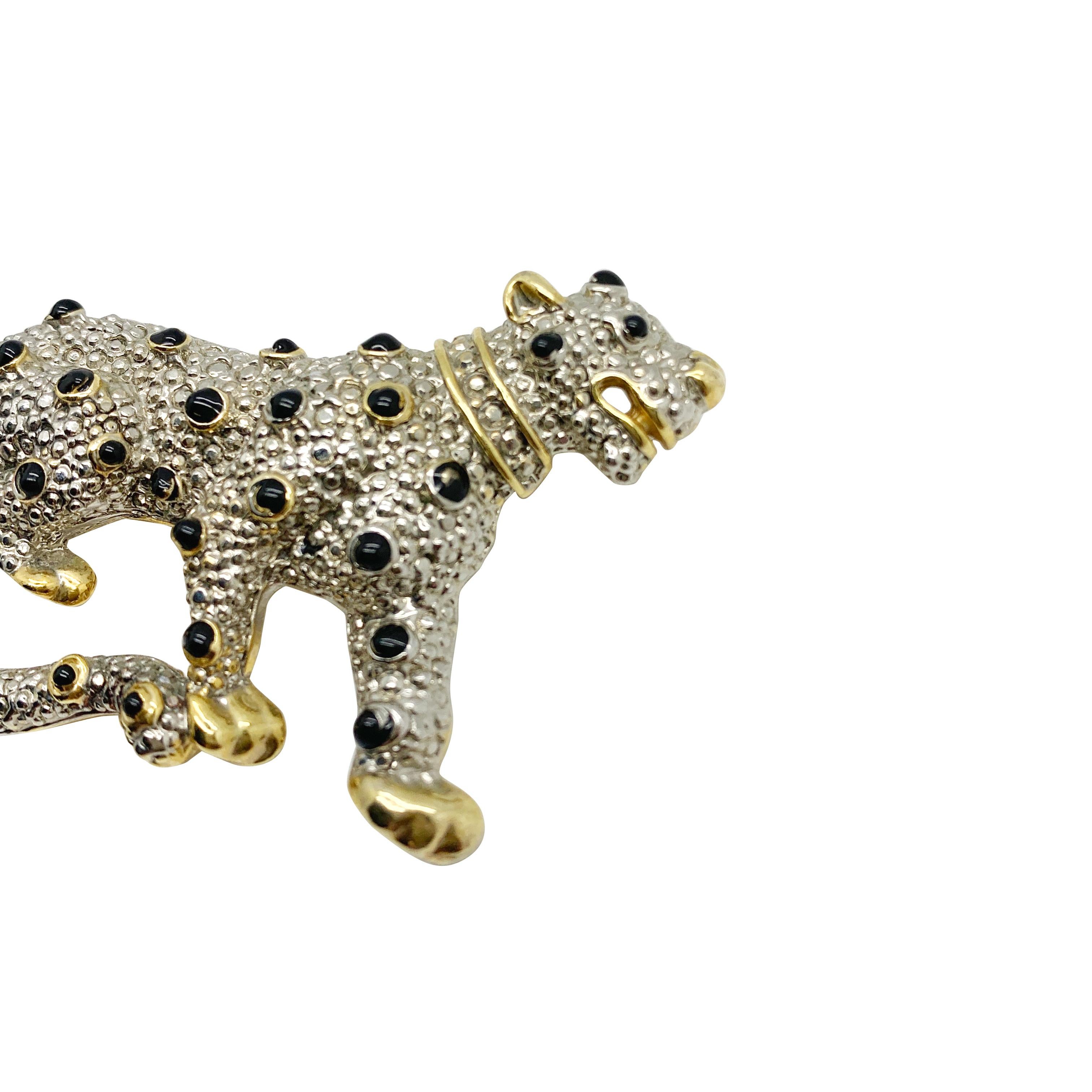 A Vintage Leopard Brooch. Featuring a full body leopard with enamelled black spots and crystal collar. Vintage Condition: Very good without damage or noteworthy wear. 
Materials: Gold plated metal, silver-tone metal, enamel, glass crystals
Signed: