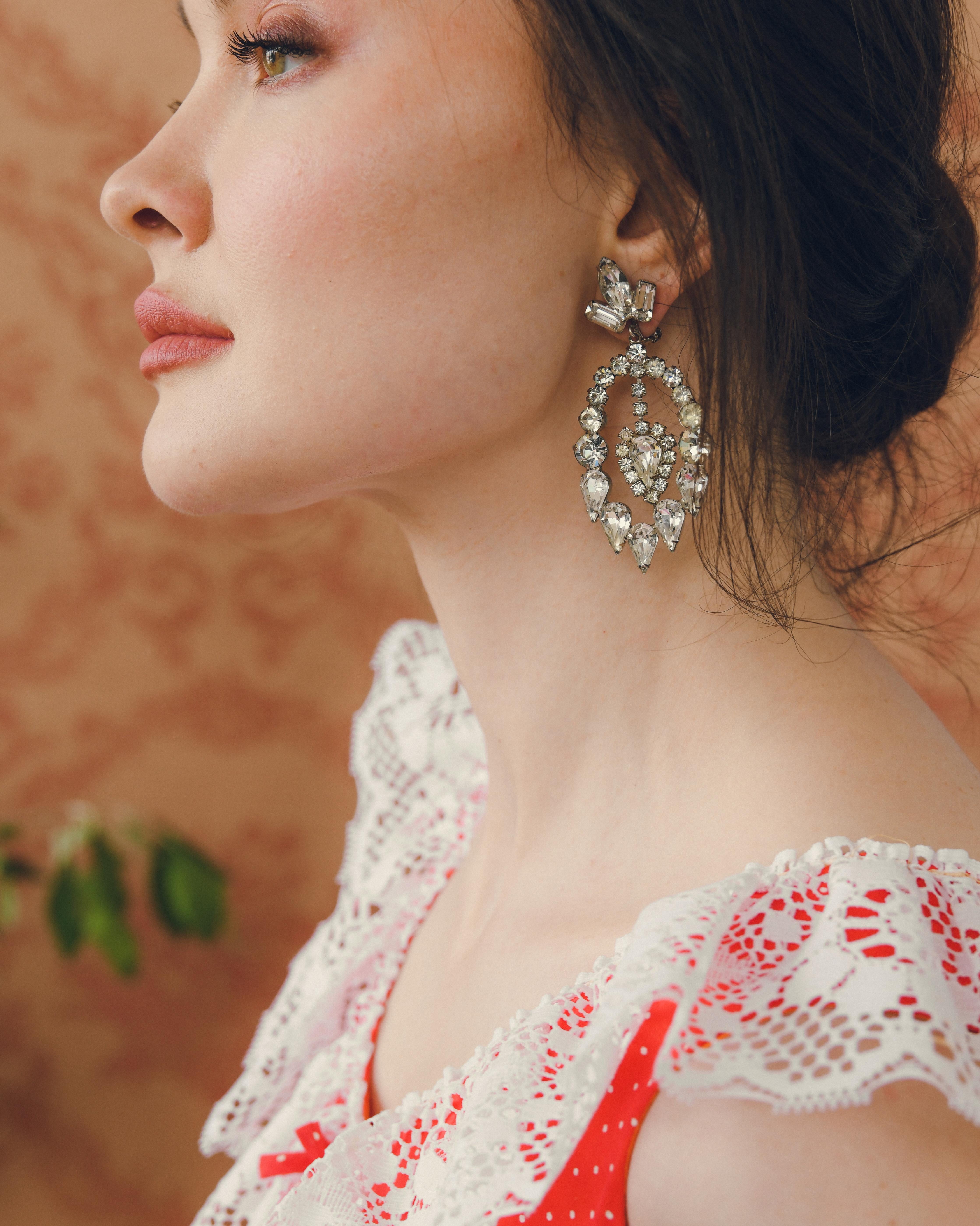 Vintage Crystal Pendant Statement Earrings: How fun are these vintage statement earrings? Circa 1960s, they feature large faceted crystals, in a variety of cuts including pear, round, baguette, and marquise, designed to sparkle like diamonds. Both